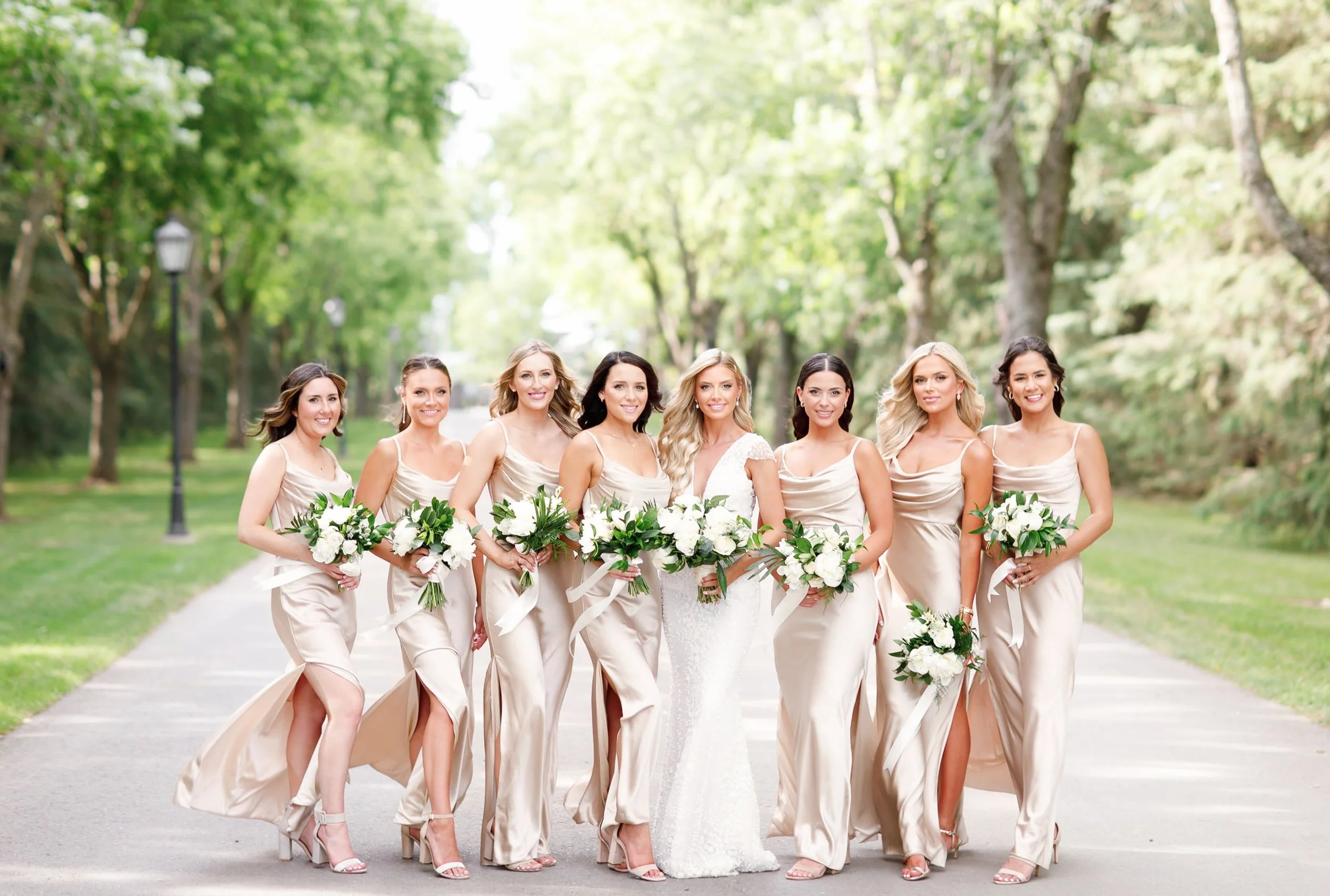 Bridesmaids posing together in the wind through the grounds of Roseville Estate during a Cambridge wedding (Copy)