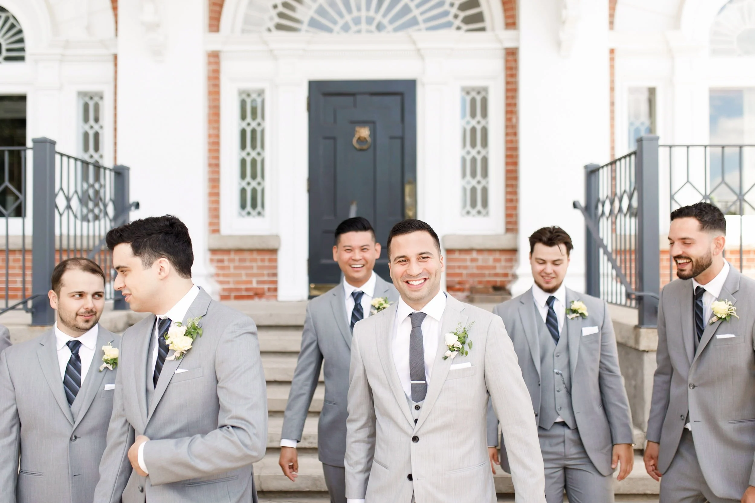 Groom and groomsmen walking together outside Langdon Hall Country House Hotel during a classic Cambridge wedding (Copy)