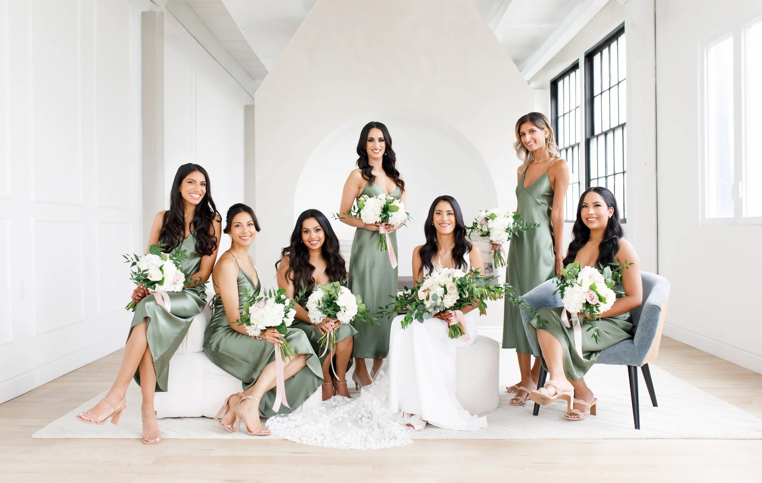 Bridesmaids seated and staggered together in soft natural light during studio wedding portraits at Park Hill Studios in Cambridge (Copy)