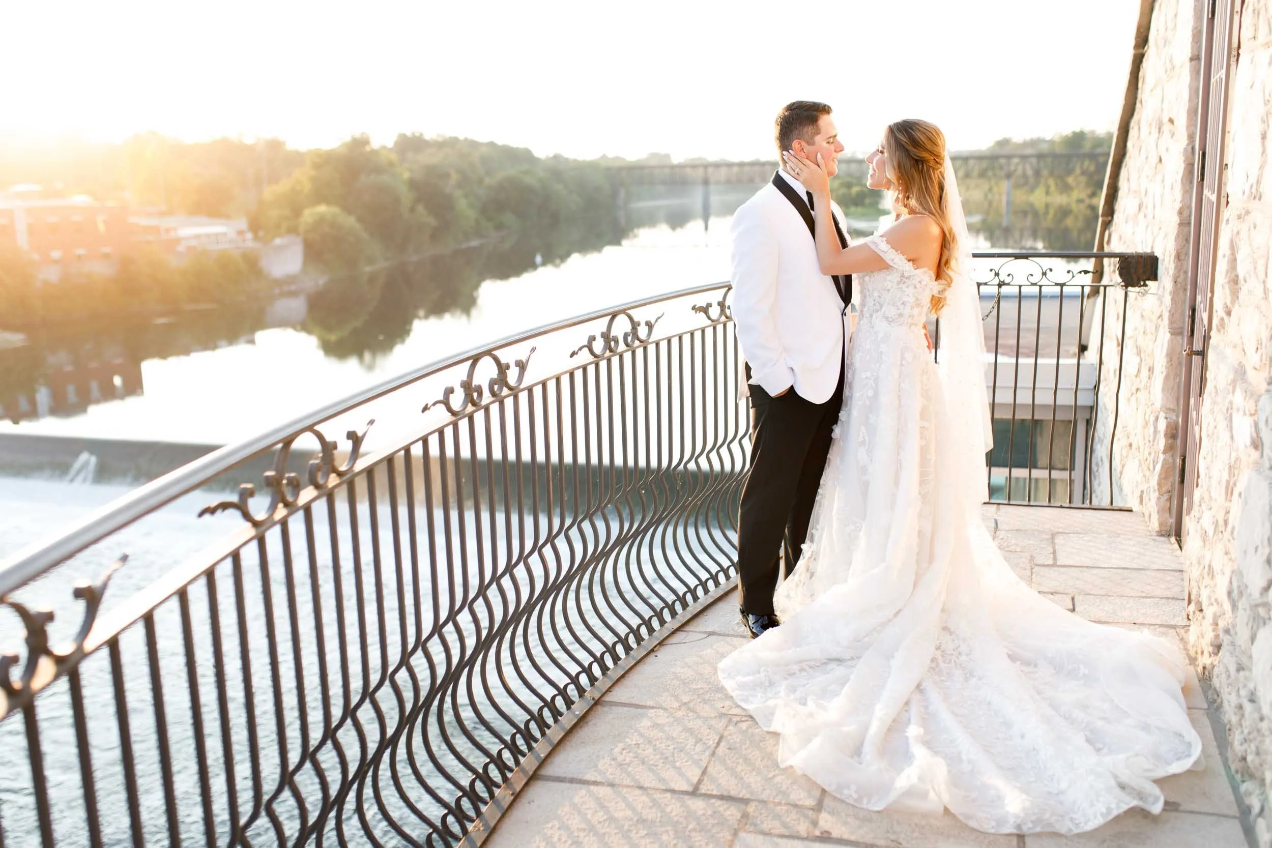 Bride and groom sharing a quiet moment on the terrace overlooking the river at Cambridge Mill during a Cambridge wedding (Copy)