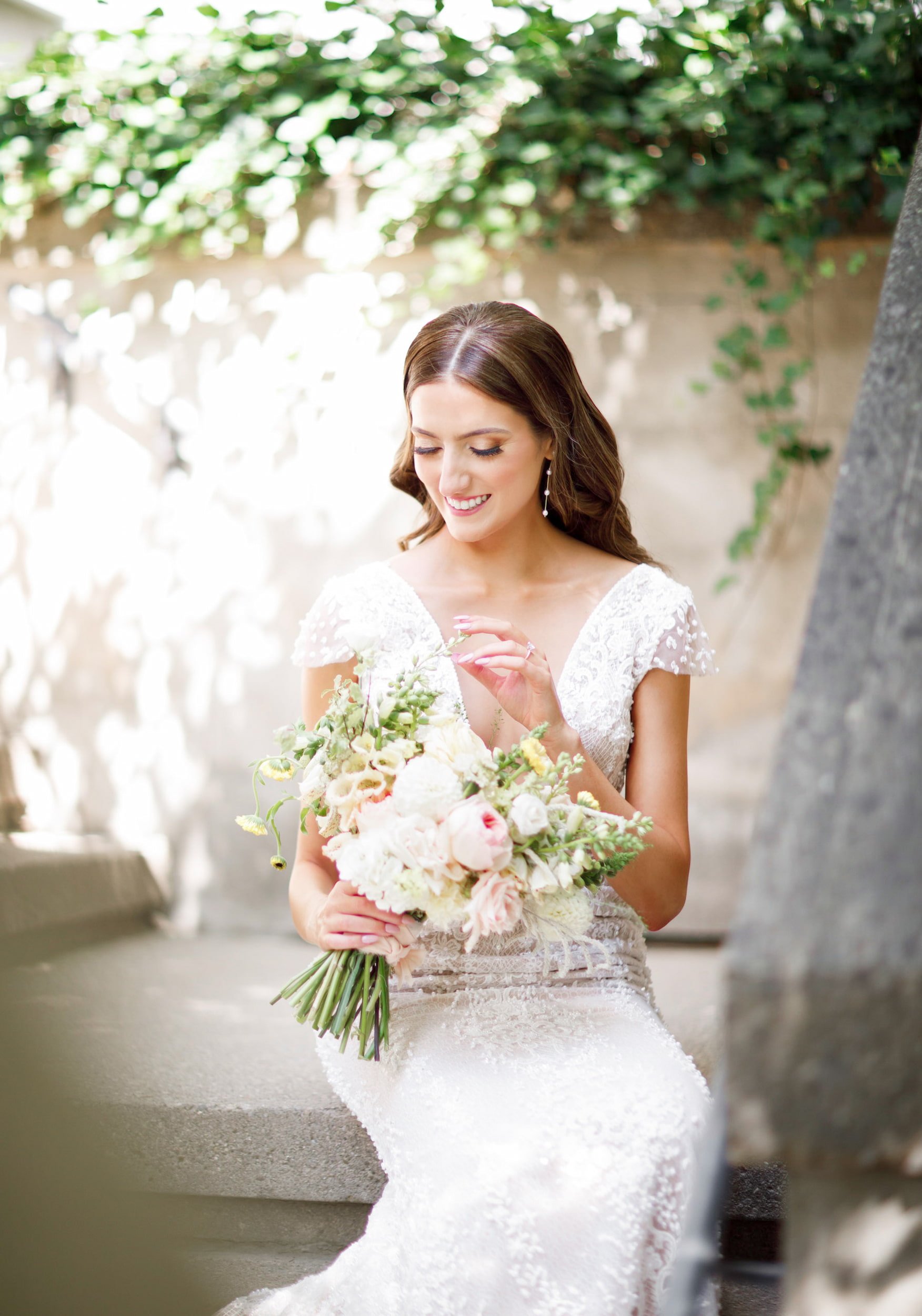 Candid bridal portrait with bouquet at Langdon Hall Country House Hotel, Cambridge - View Wedding Portfolio