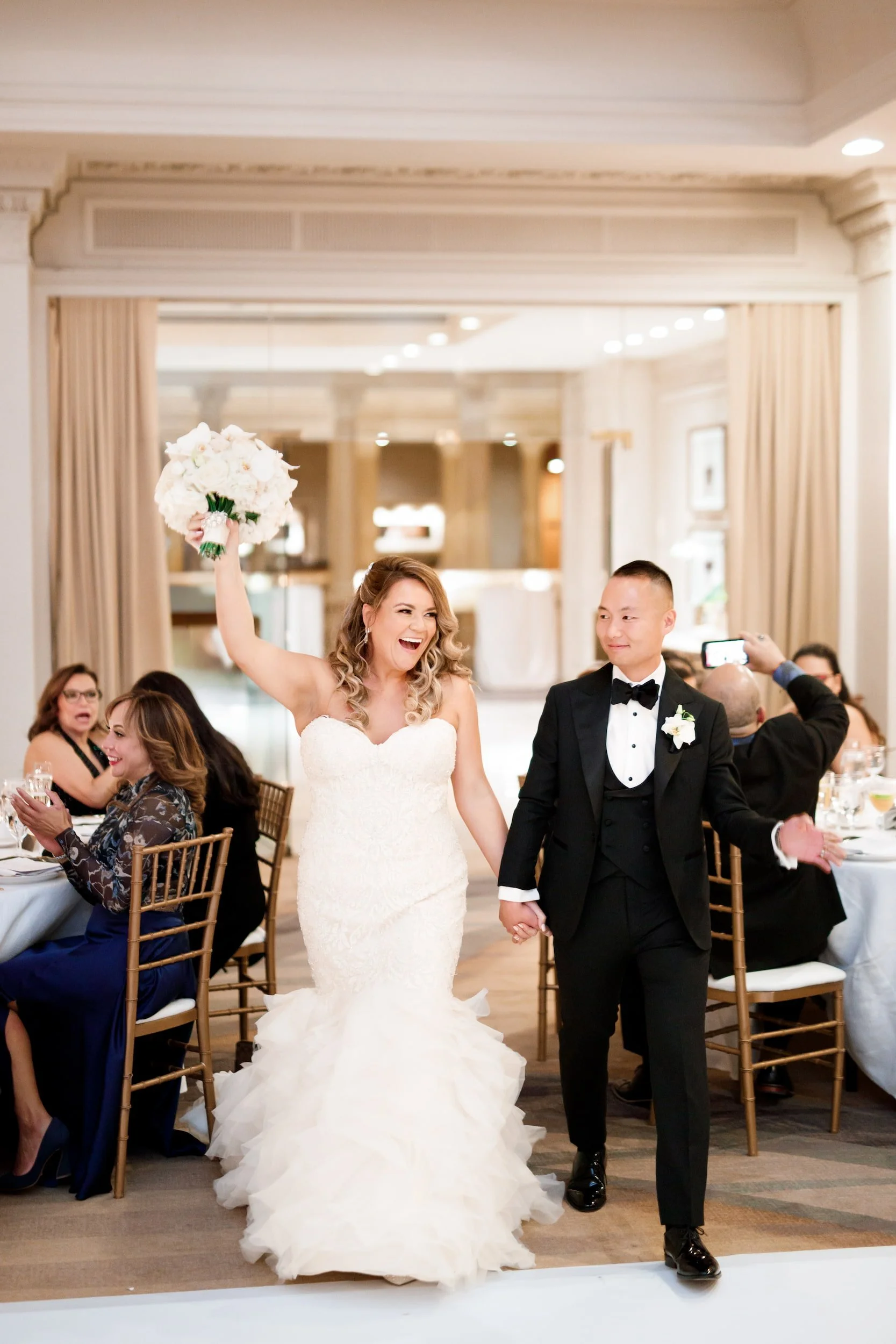 Bride and groom grand entrance in the Vanity Fair Ballroom at Omni King Edward Hotel in Toronto
