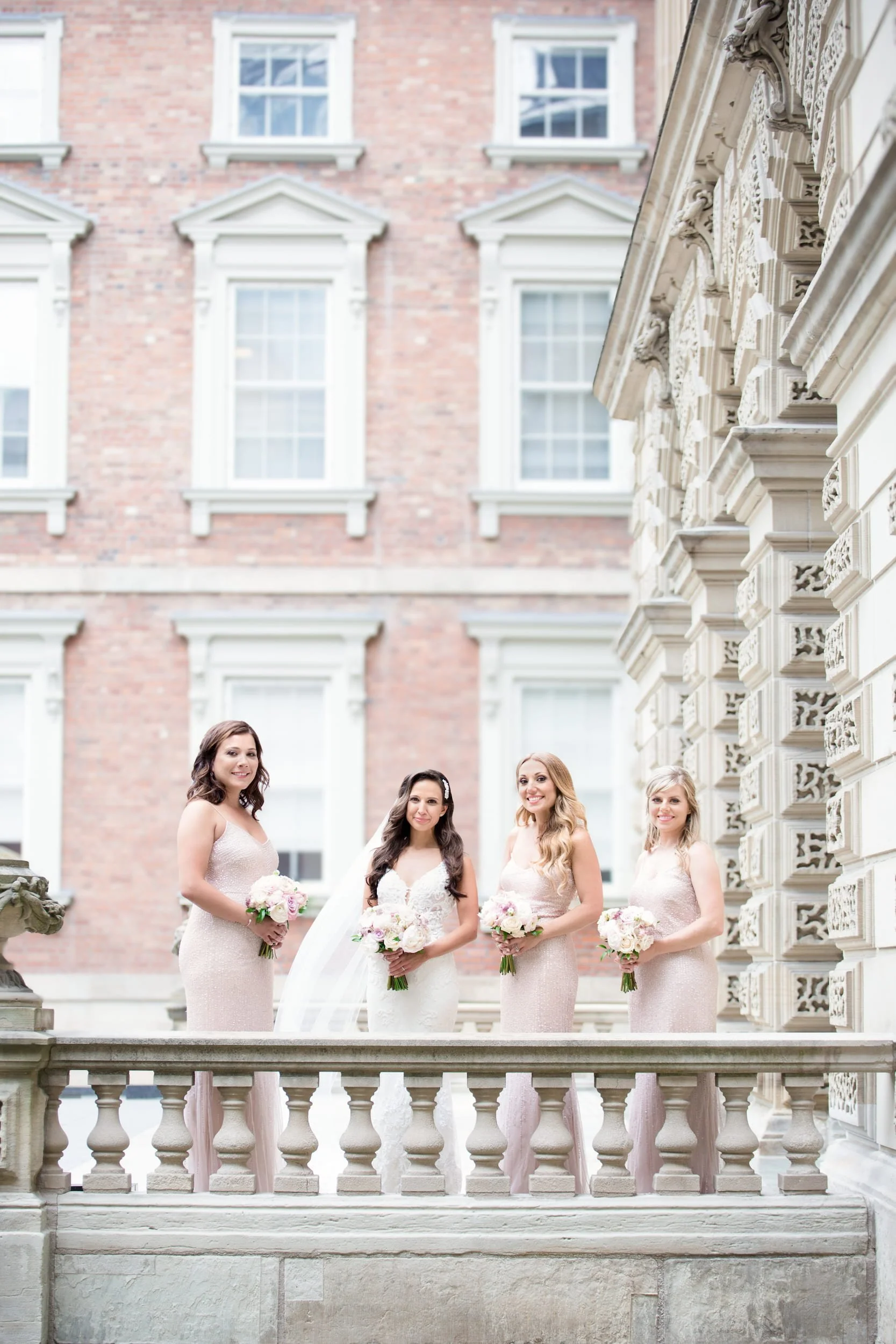 Bridesmaids portrait along balustrade at Osgoode Hall in downtown Toronto