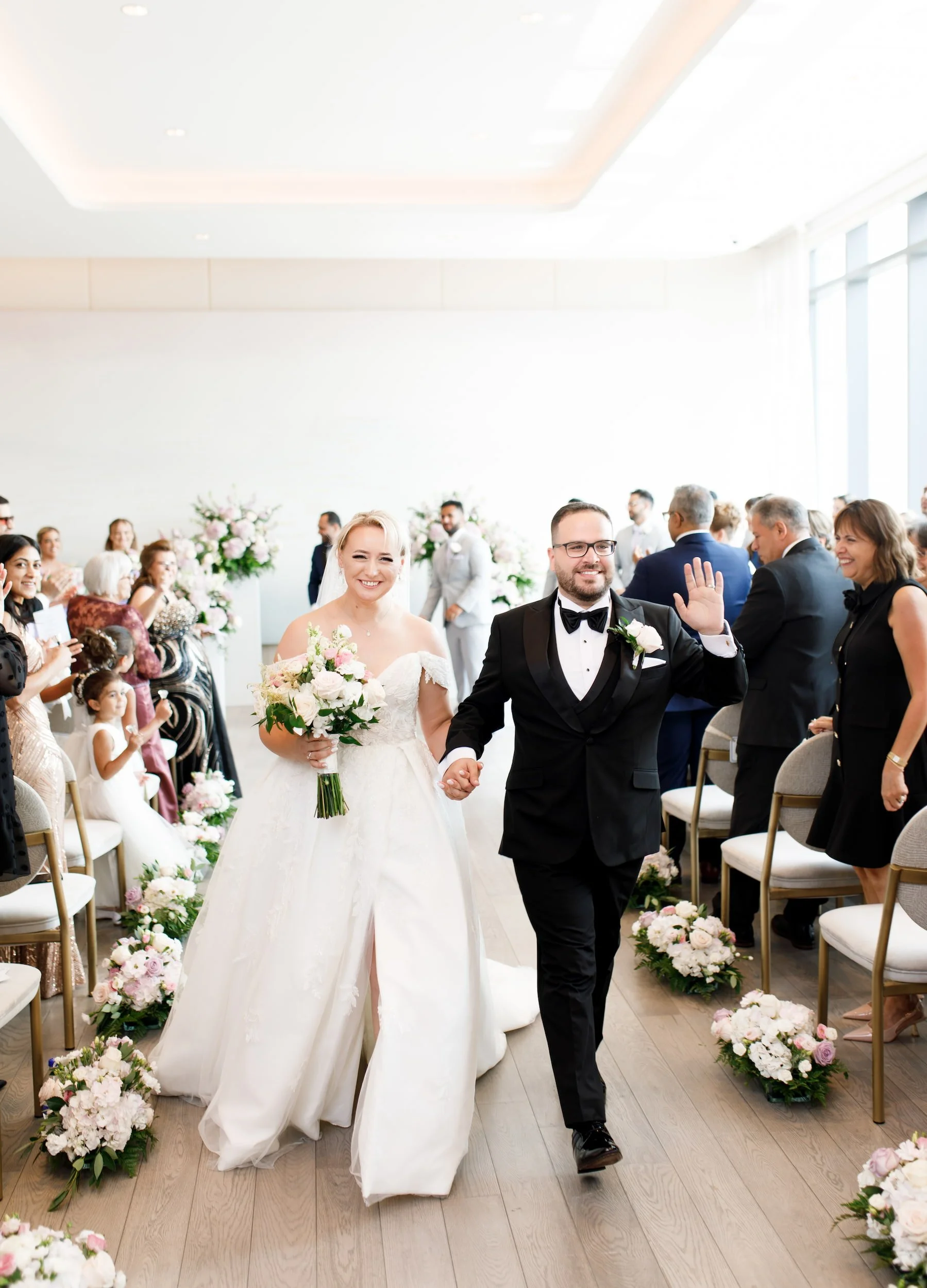 Bride and groom recessional inside The Pearle Hotel ballroom in Burlington, Ontario
