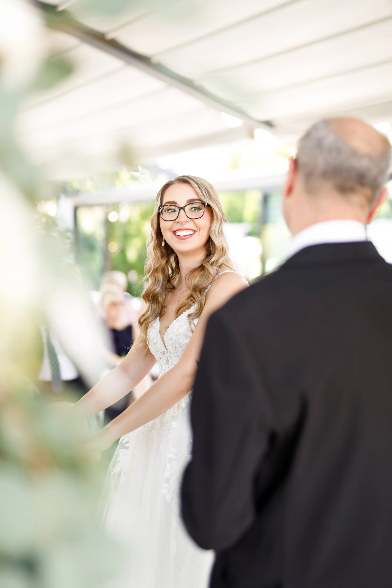 Bride smiling during ceremony at Whistle Bear Golf Club in Cambridge, Ontario