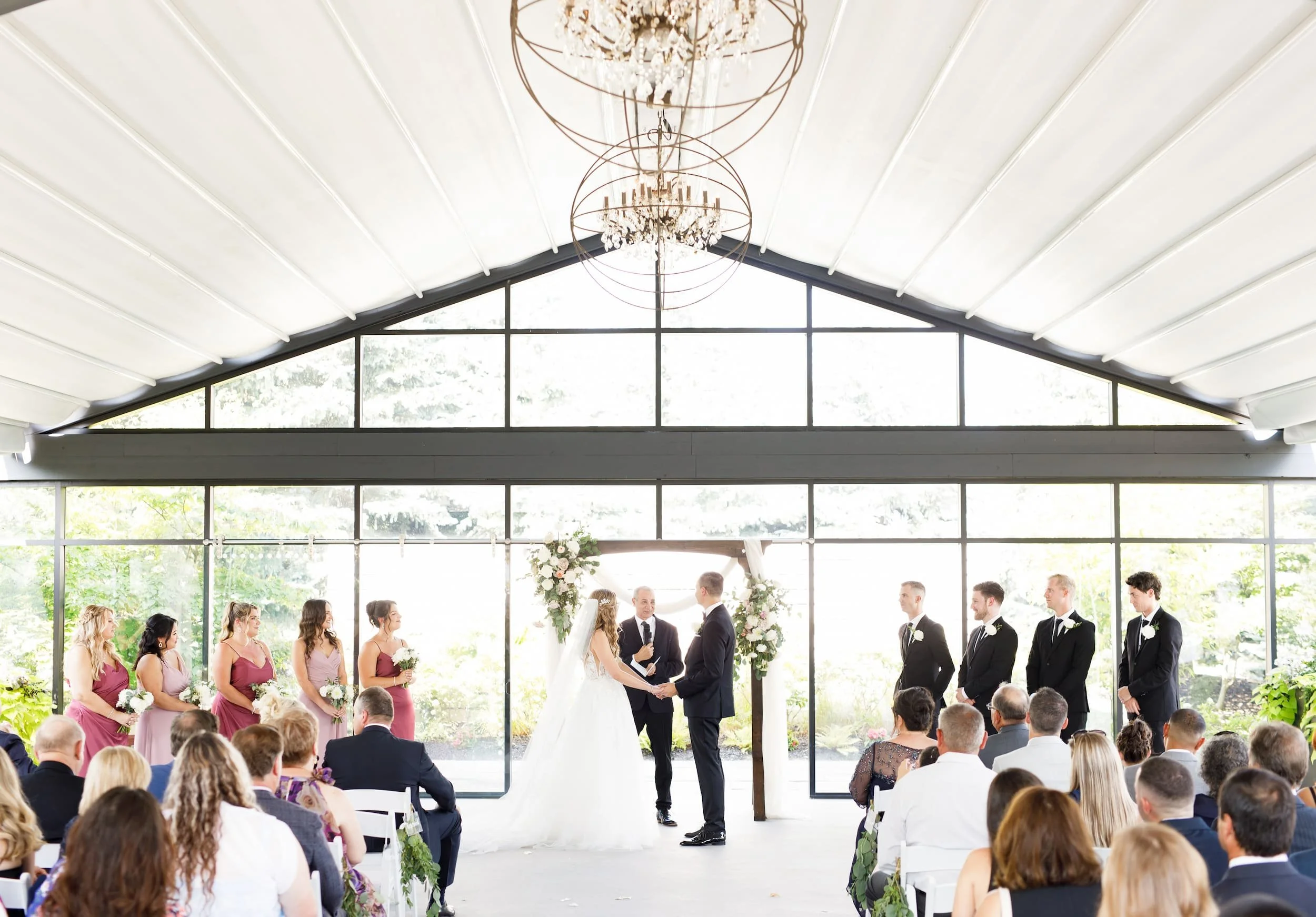 Wedding ceremony inside the white canopy pavilion at Whistle Bear Golf Club in Cambridge, Ontario