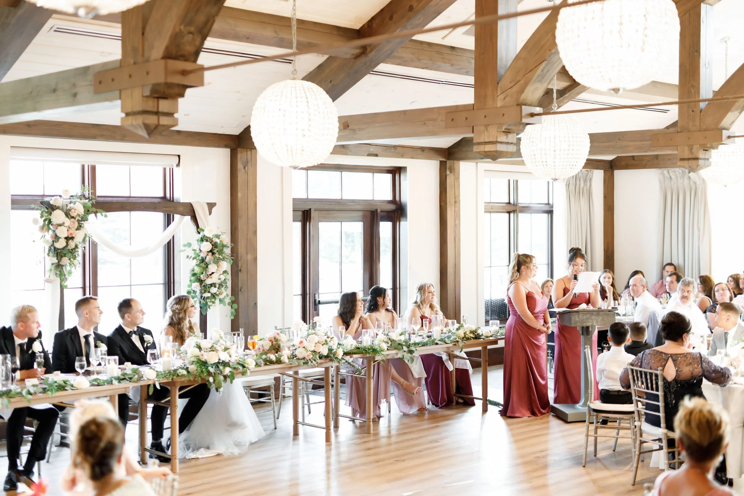Reception speech inside timber-beamed hall at Whistle Bear Golf Club in Cambridge, Ontario