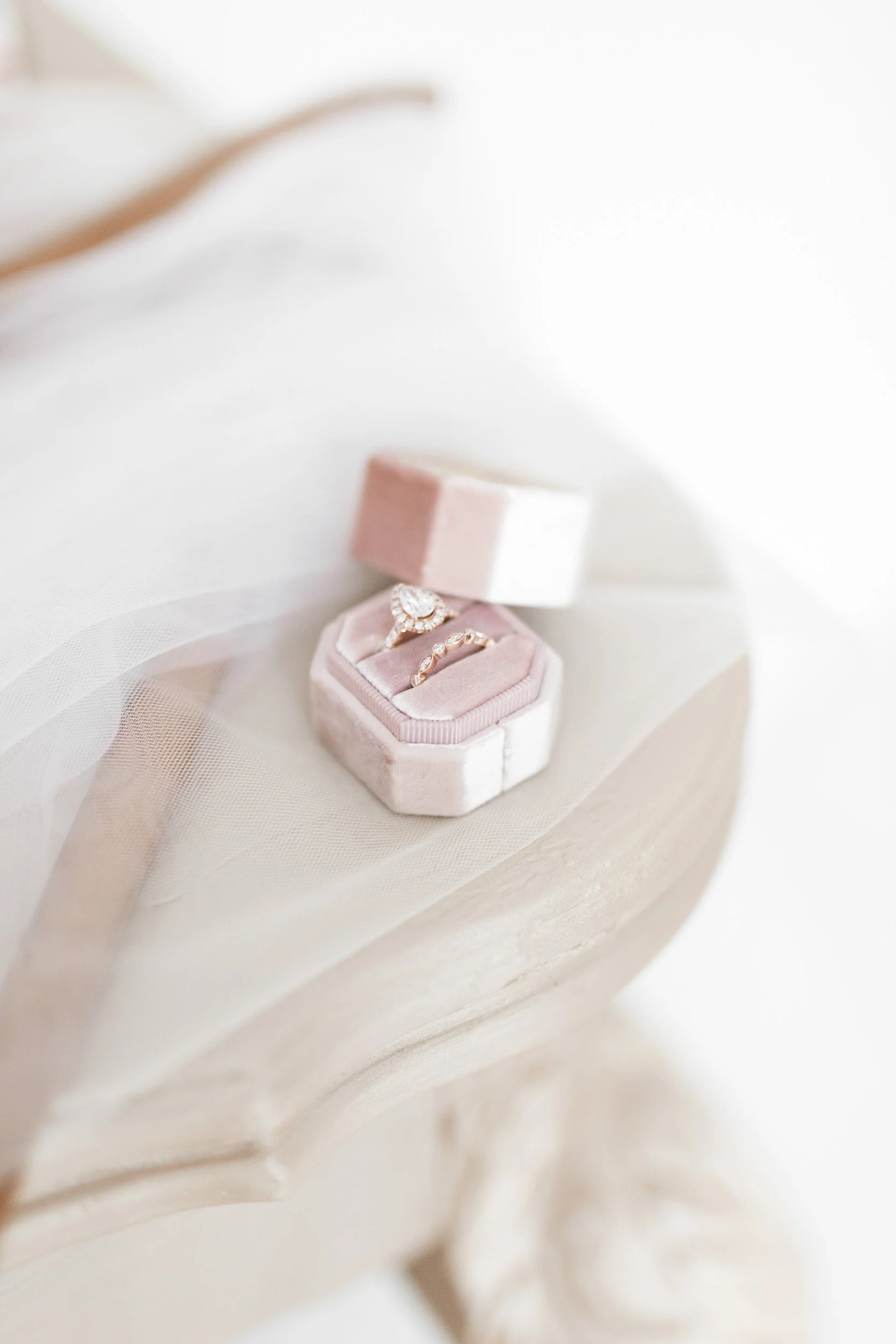 Wedding rings resting on veil during bridal detail photography at La Petite Chappelle in Innerkip, Ontario