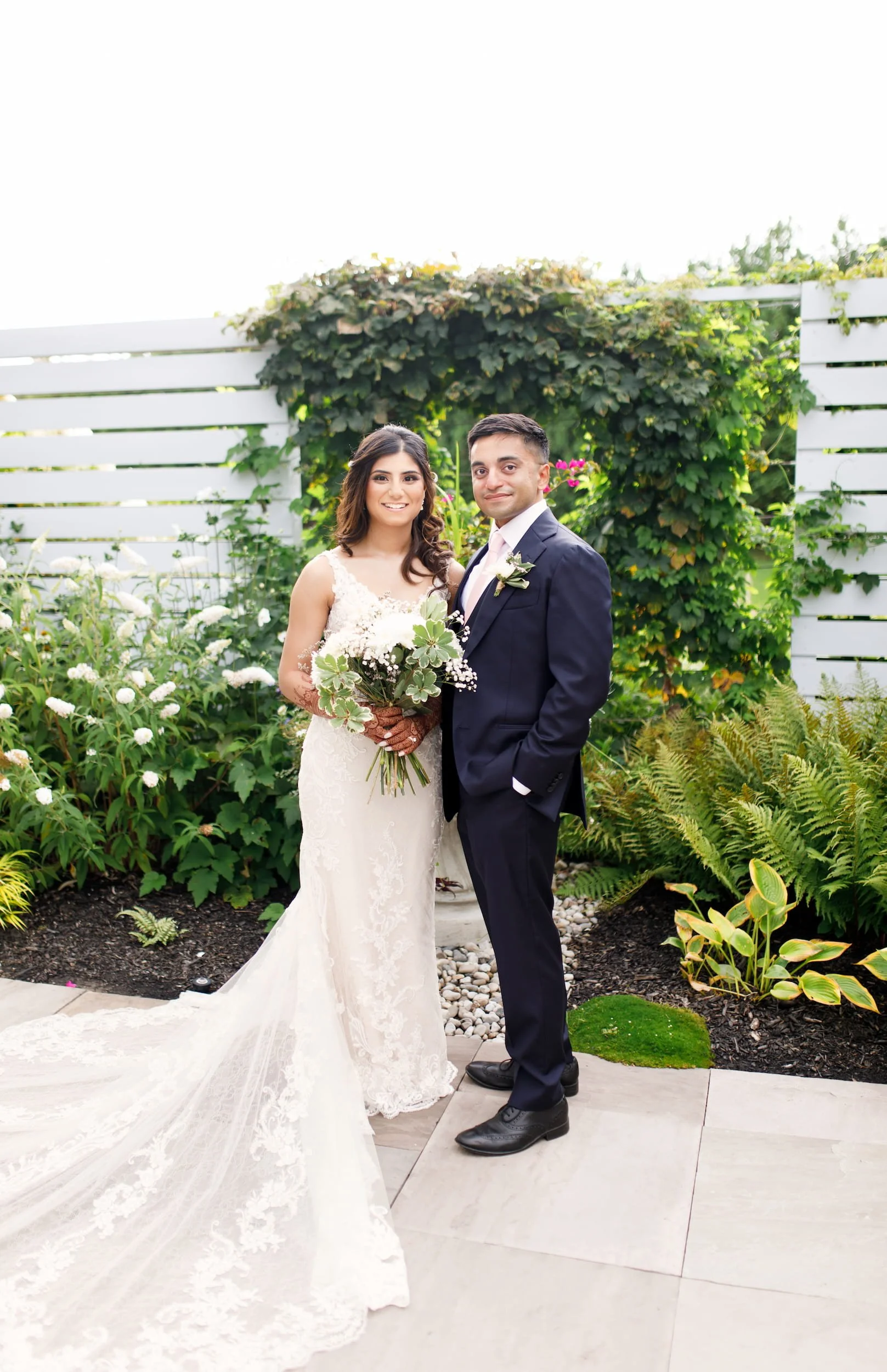 Wedding portrait against floral garden backdrop at Whistle Bear Golf Club in Cambridge, Ontario