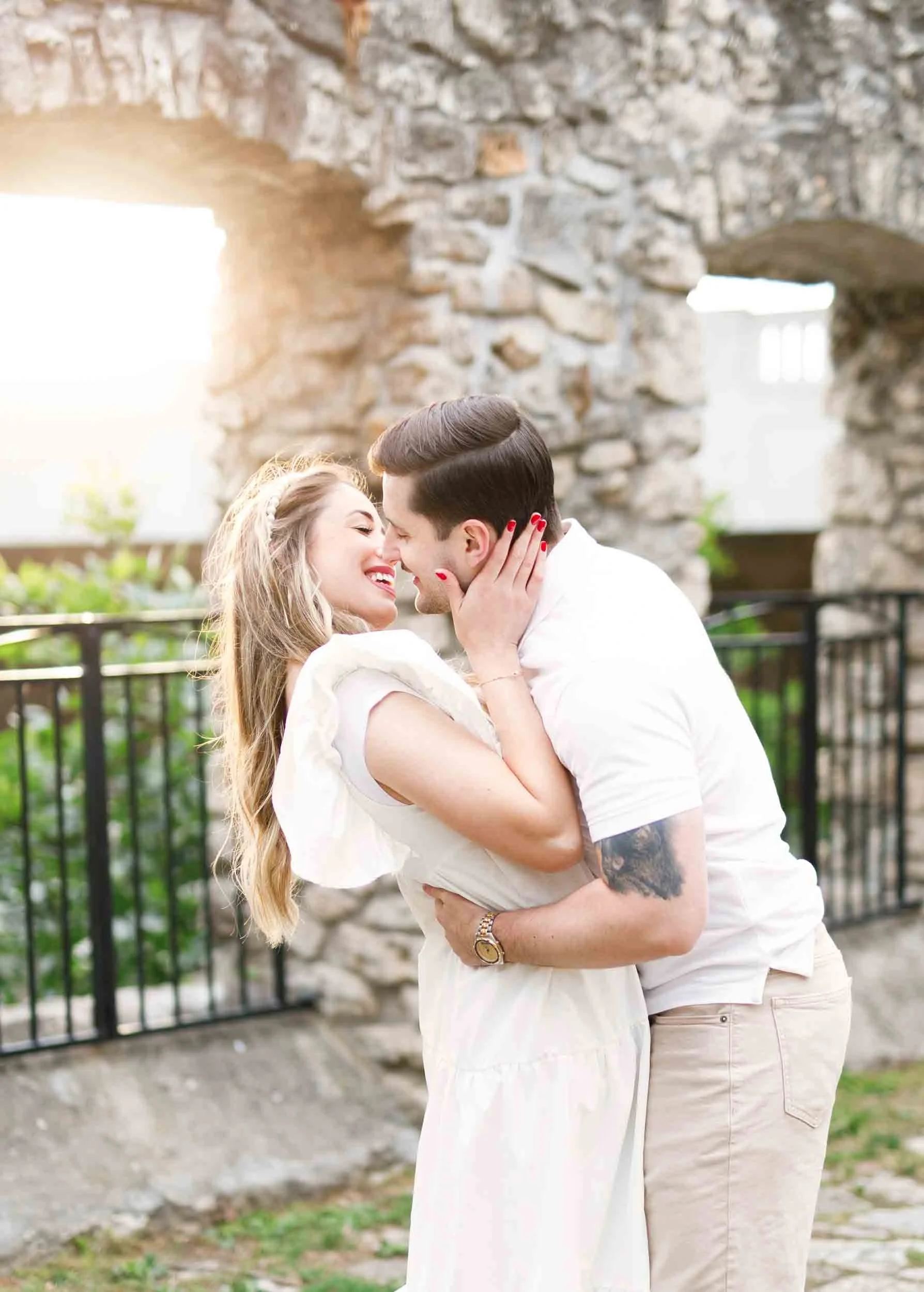 Sunset kiss at historic stone ruins near Cambridge Mill wedding venue
