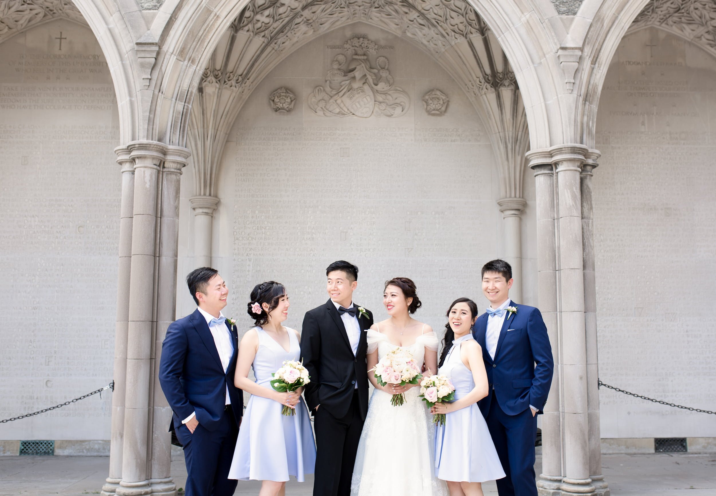 Wedding party portrait framed by Gothic architecture at Knox College, University of Toronto in Toronto, Ontario