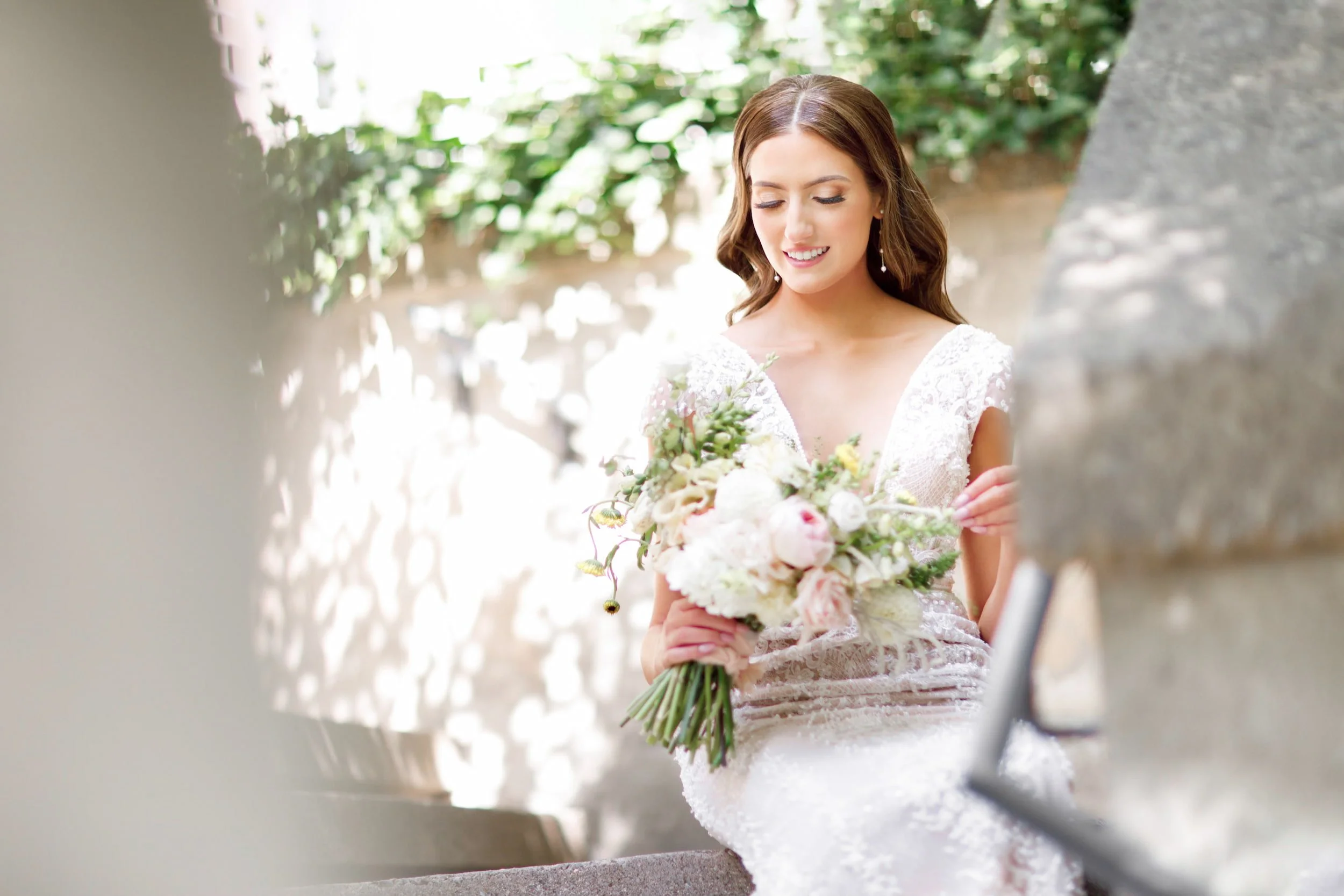 Bride holding a bouquet during elegant wedding portraits on the grounds of Langdon Hall Country House Hotel in Cambridge, Ontario
