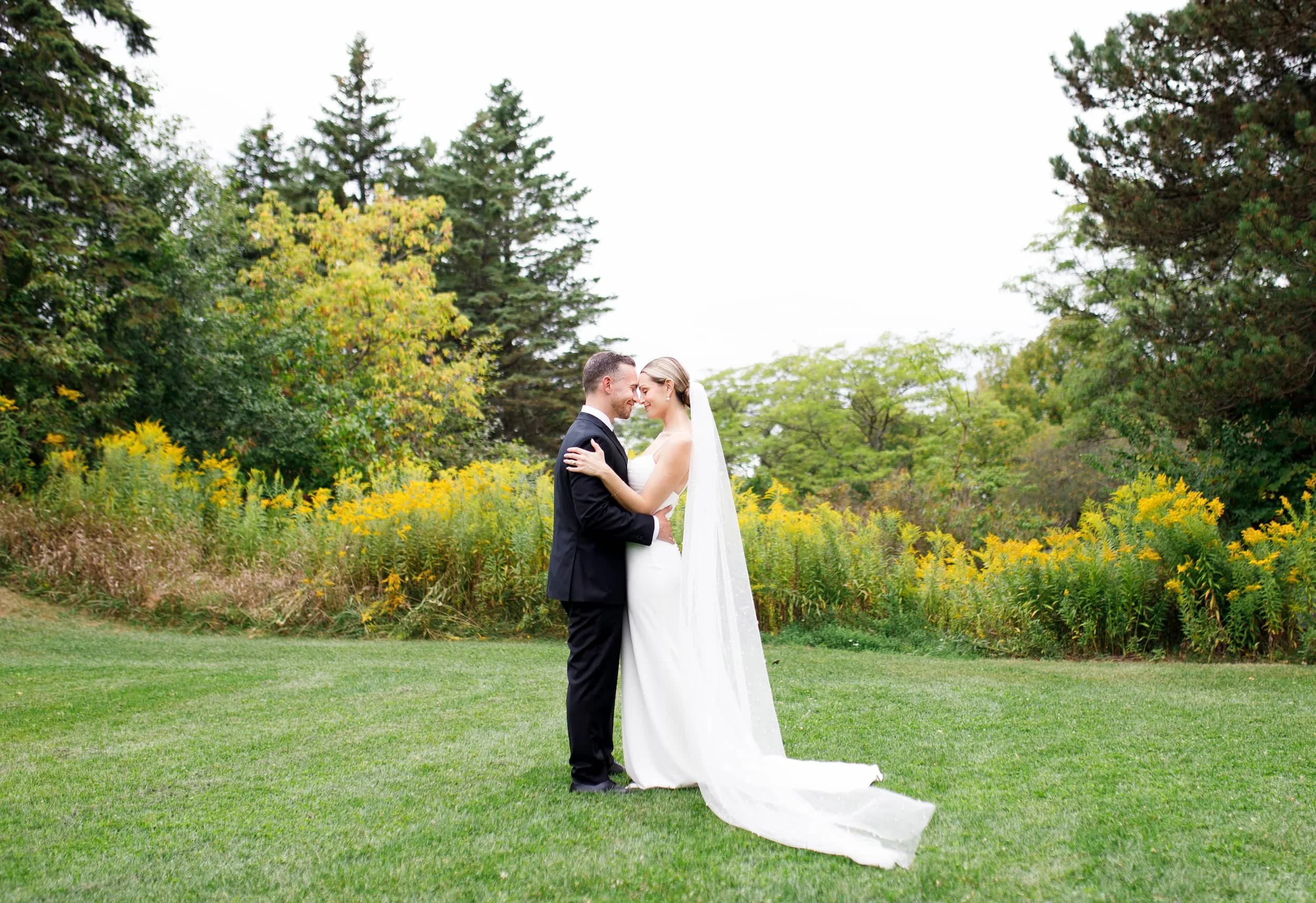 Bride and groom sharing a quiet moment on the grounds of The Manor Event Venue in King, Ontario