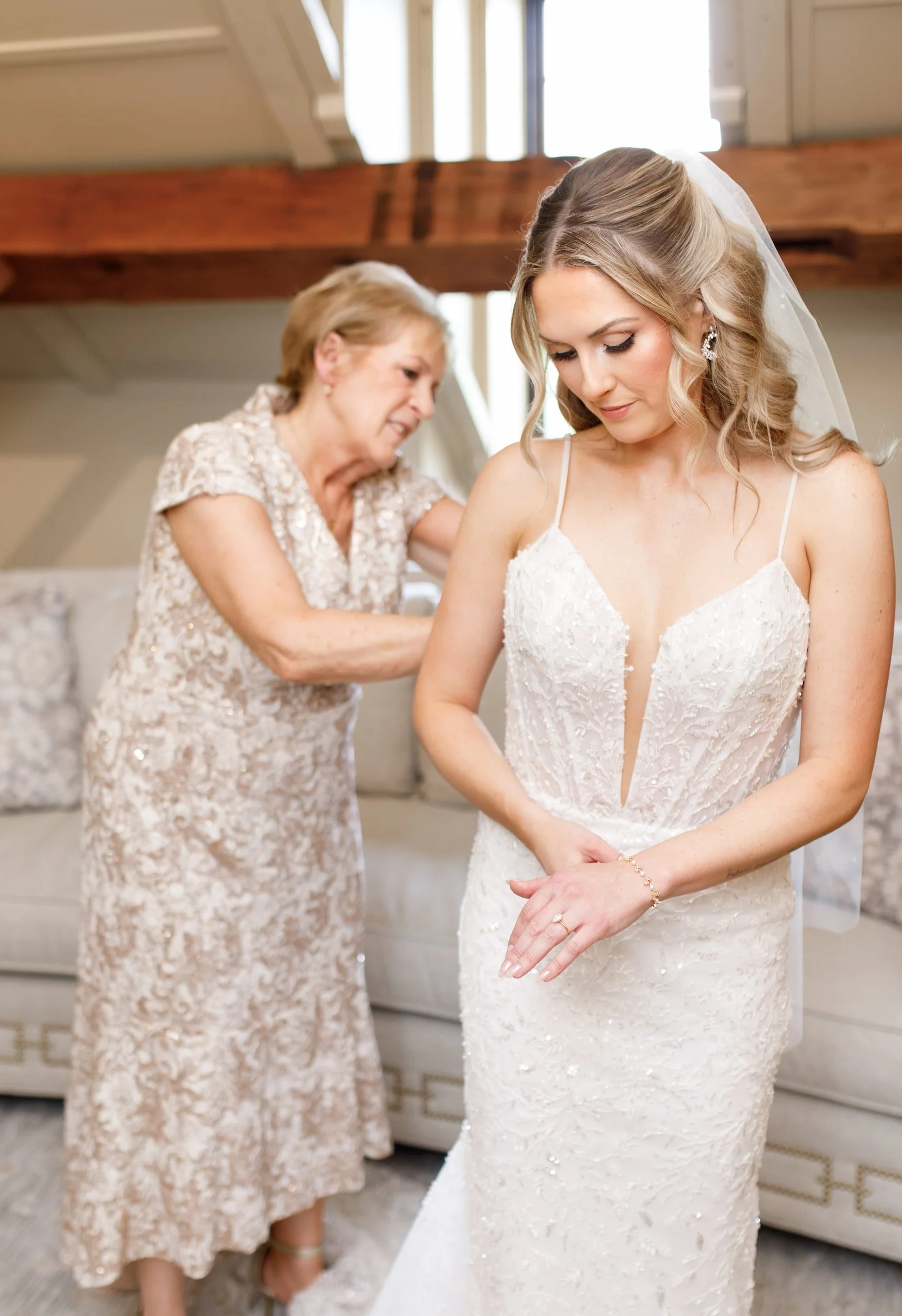 Mother helping bride with dress at the Ancaster Mill bridal suite