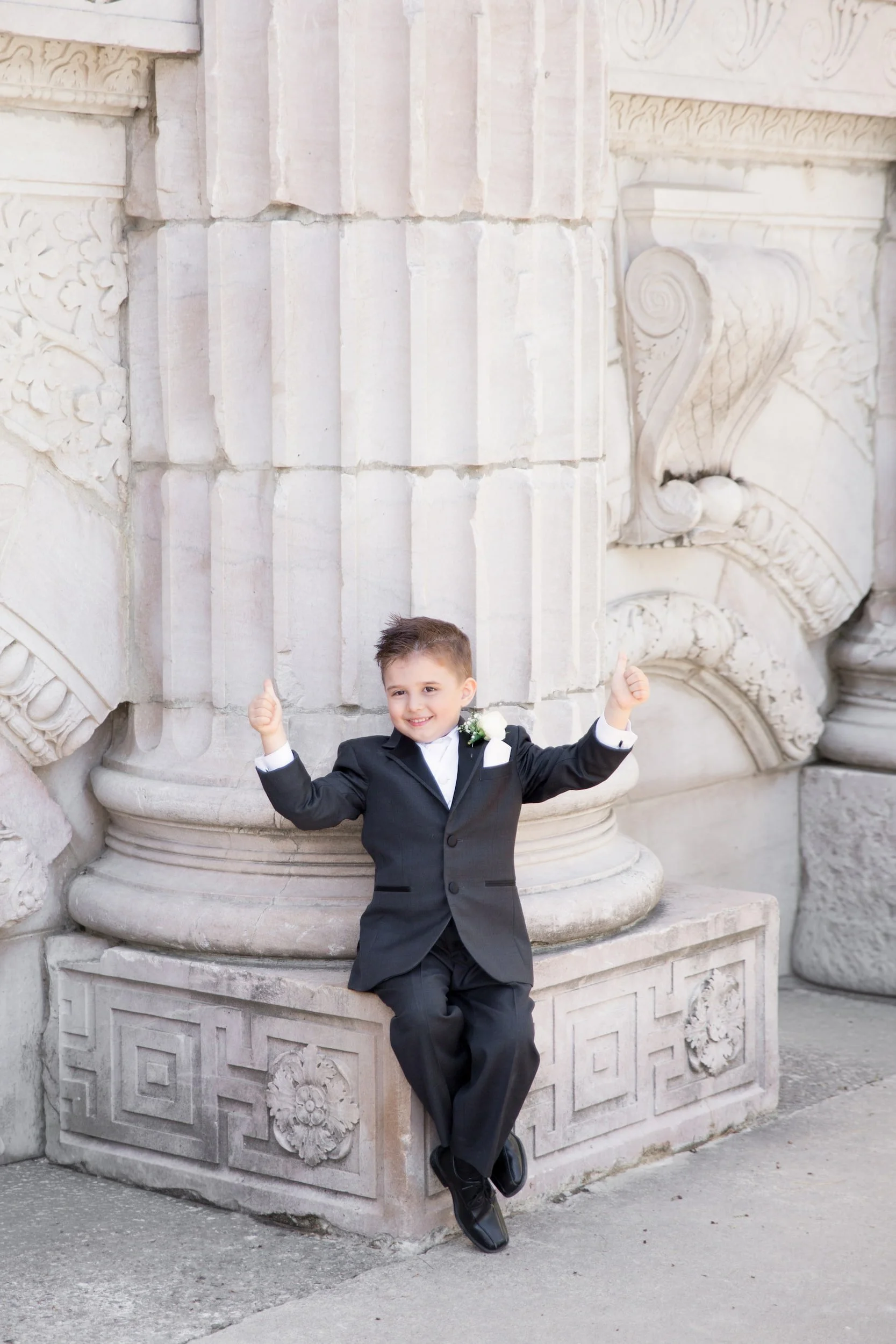 Ring bearer portrait beside Guild Inn Estate stone column