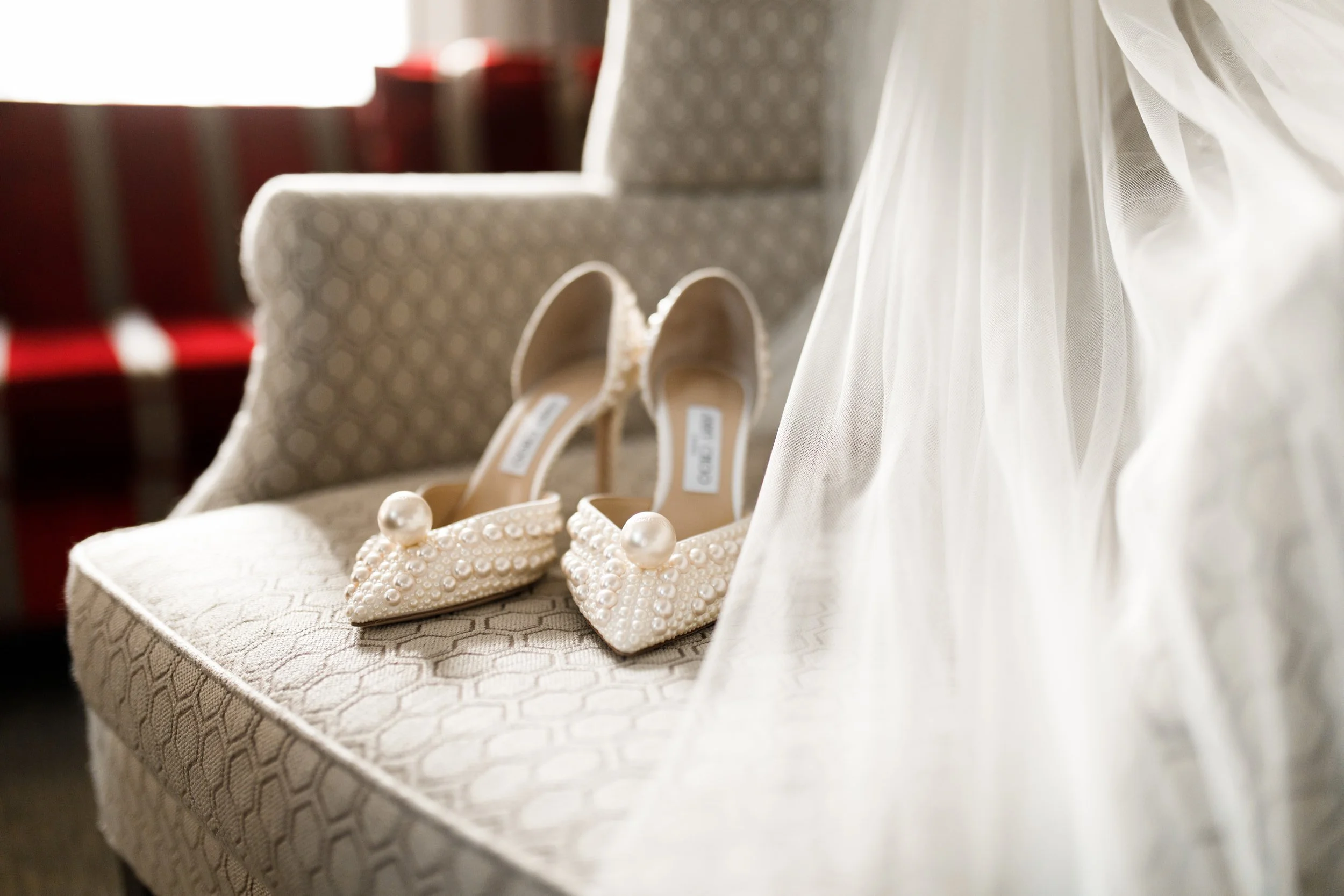Bridal wedding shoes beside veil in getting ready suite at Omni King Edward Hotel Toronto