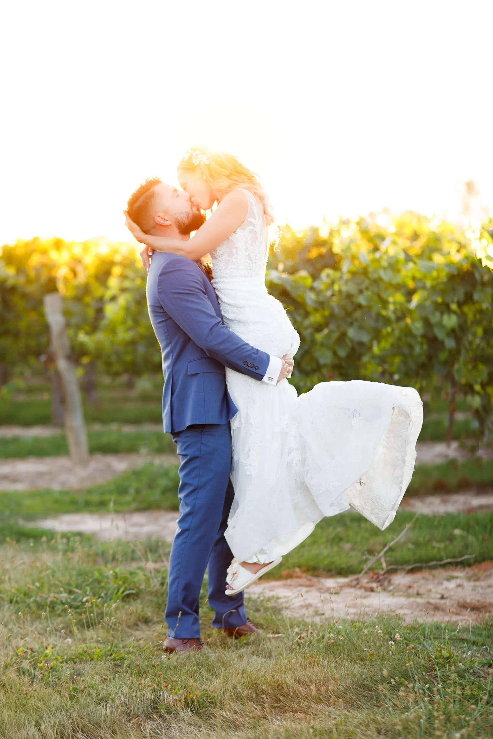 Bride and groom lifted in the vineyard at Kurtz Orchards