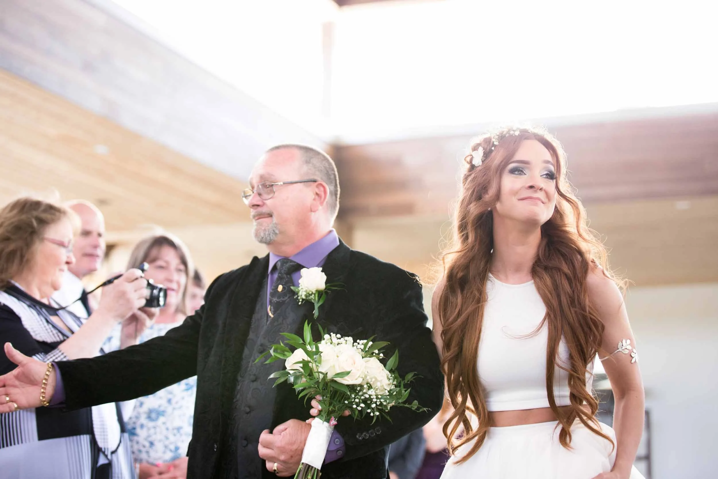 Bride walking down the aisle with her father at Guild Inn Estate indoor ceremony
