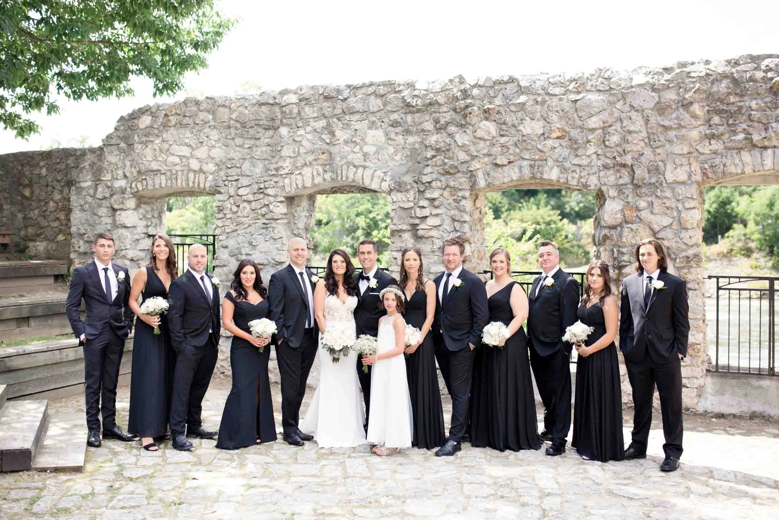 Wedding party portrait at Mill Race Park historic stone ruins near Cambridge Mill in Cambridge, Ontario