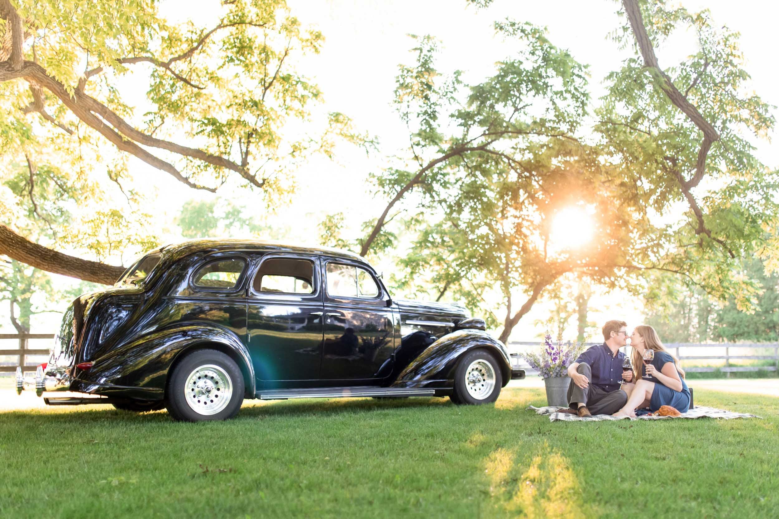 Engagement session picnic at Bannockburn 1878 in Clinton, Ontario with a vintage Rolls-Royce at sunset