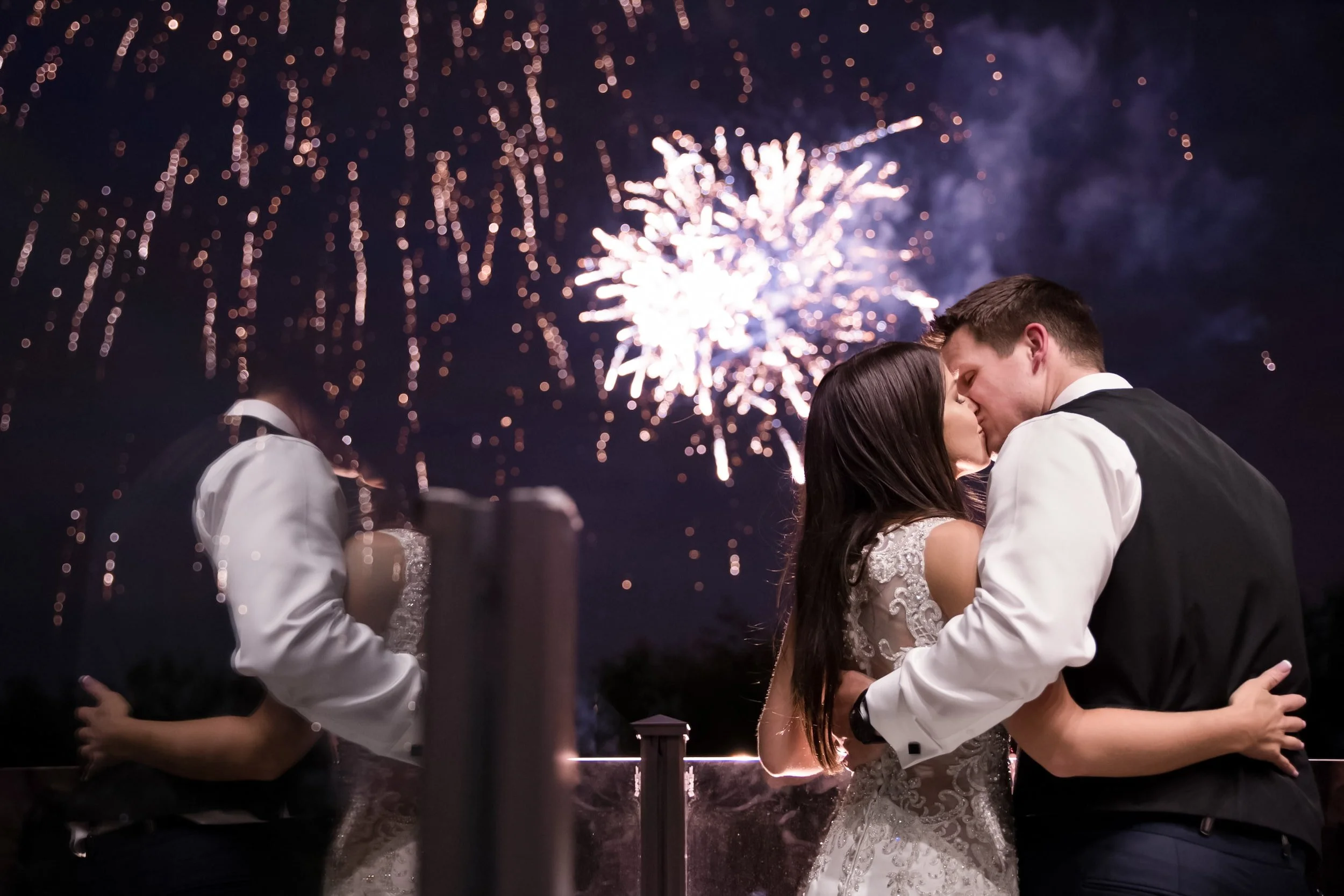 Bride and groom kissing beneath fireworks at the Arlington Estate in Vaughan