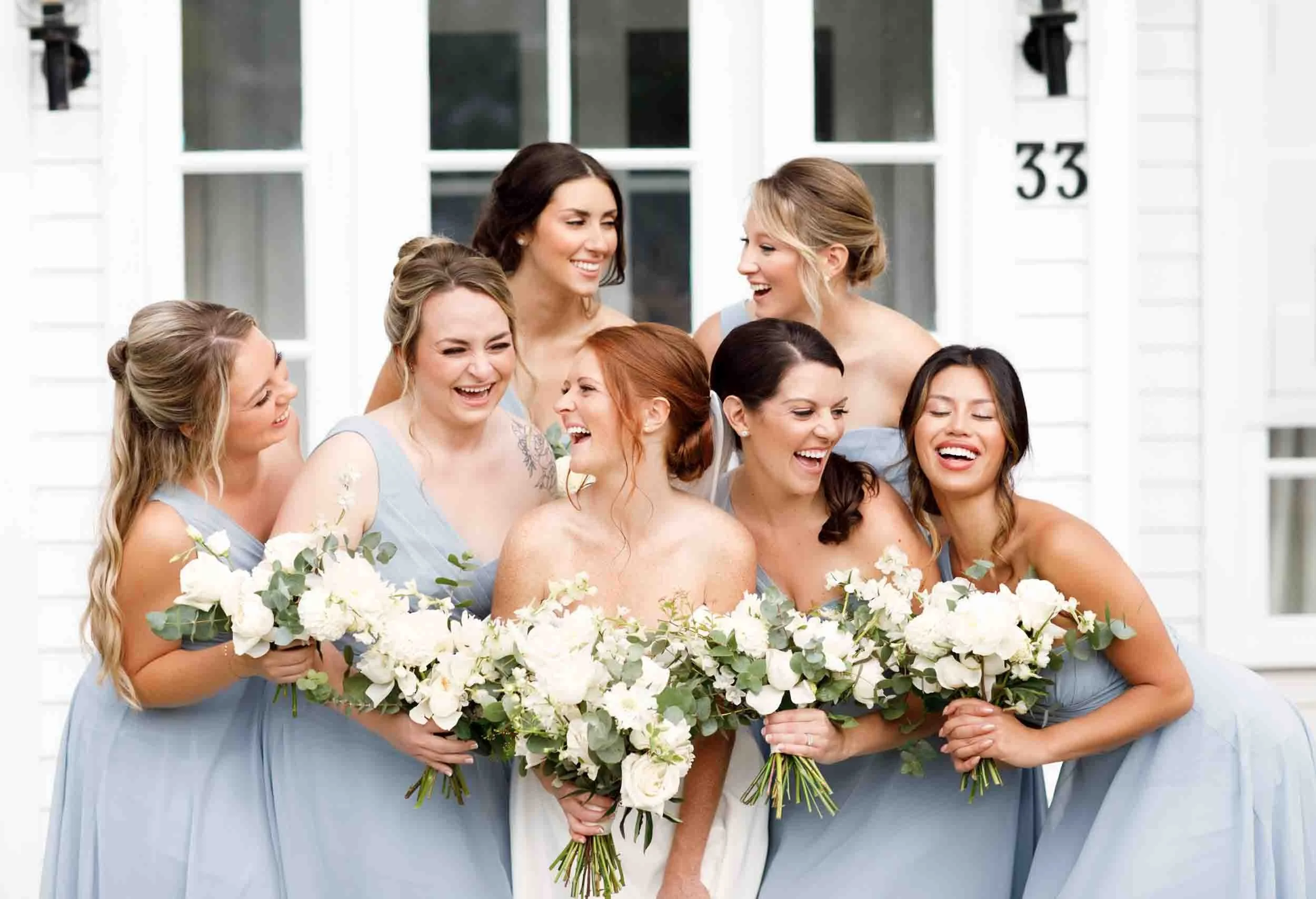 Bridesmaids laughing in garden setting at The Doctor’s House in Kleinburg, Ontario