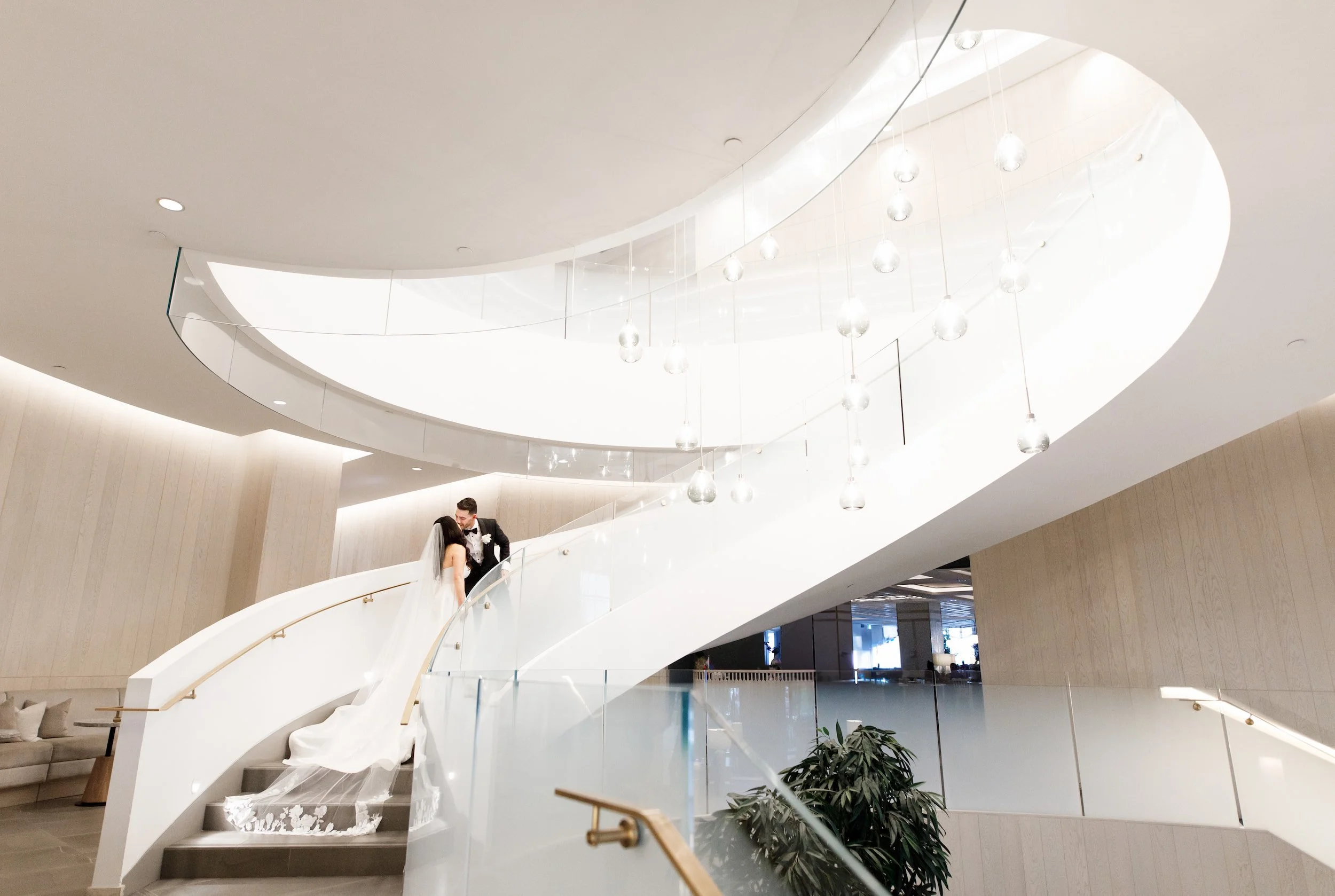 Bride and groom portrait on curved staircase inside The Pearle Hotel & Spa in Burlington, Ontario