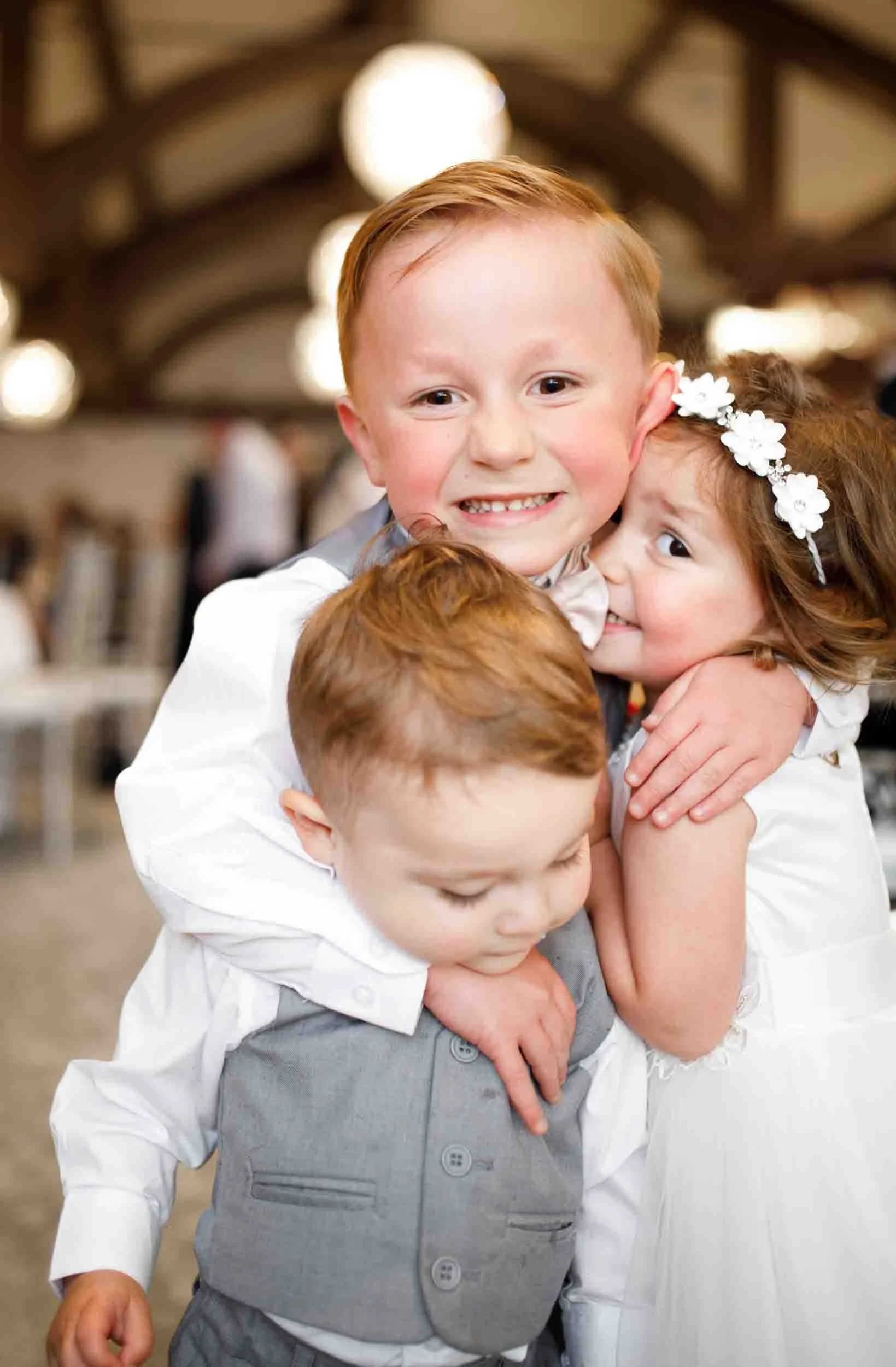 Children hugging during reception at Whistle Bear Golf Club wedding in Cambridge, Ontario