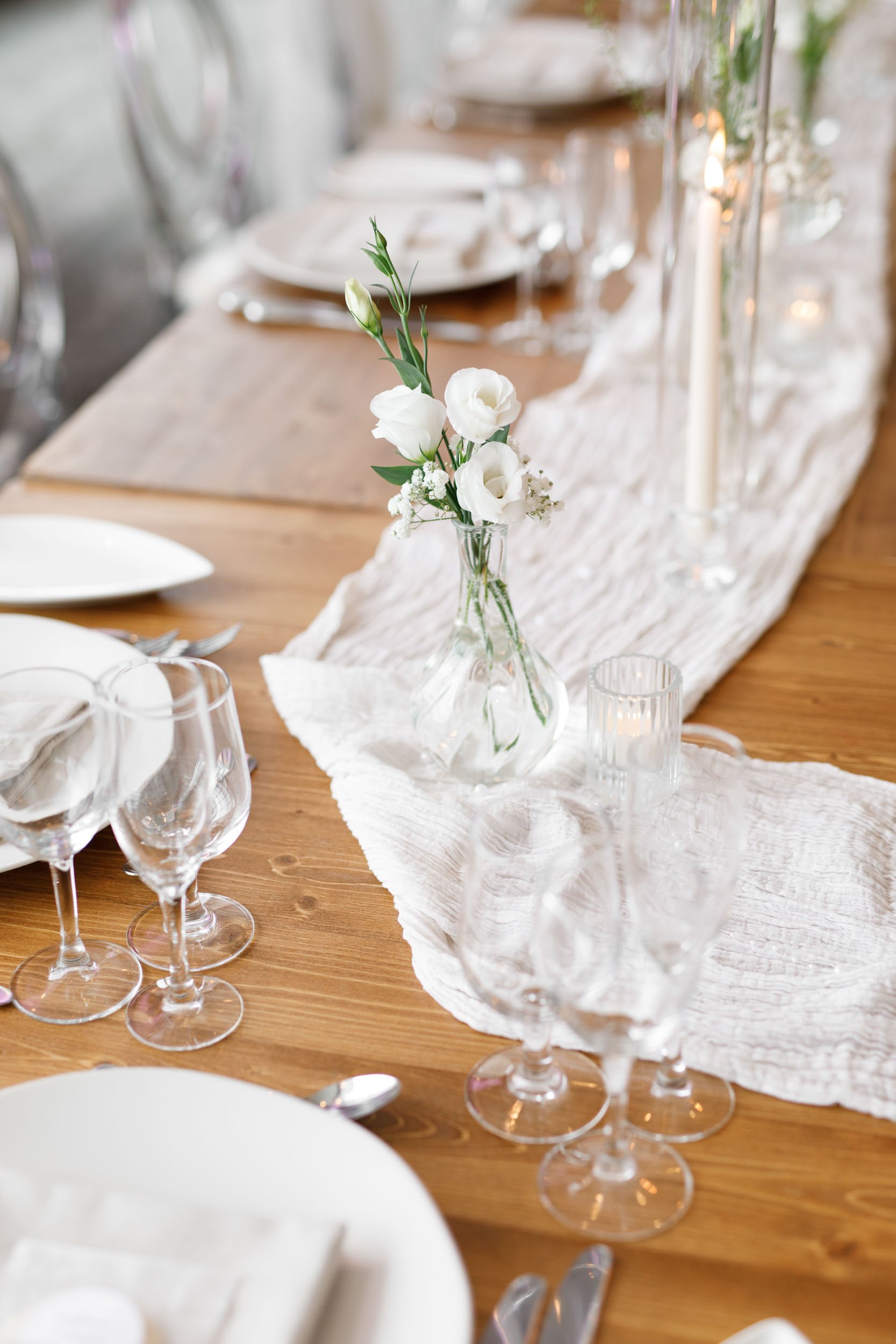 Elegant reception table details with white florals and glassware at The Manor Event Venue wedding in King, Ontario