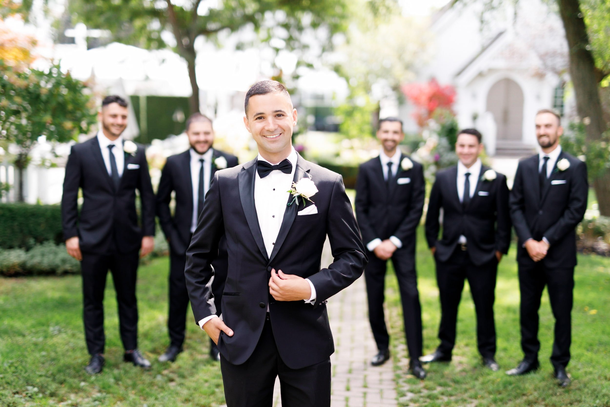 Groom with groomsmen in courtyard at The Doctor’s House wedding in Kleinburg, Ontario