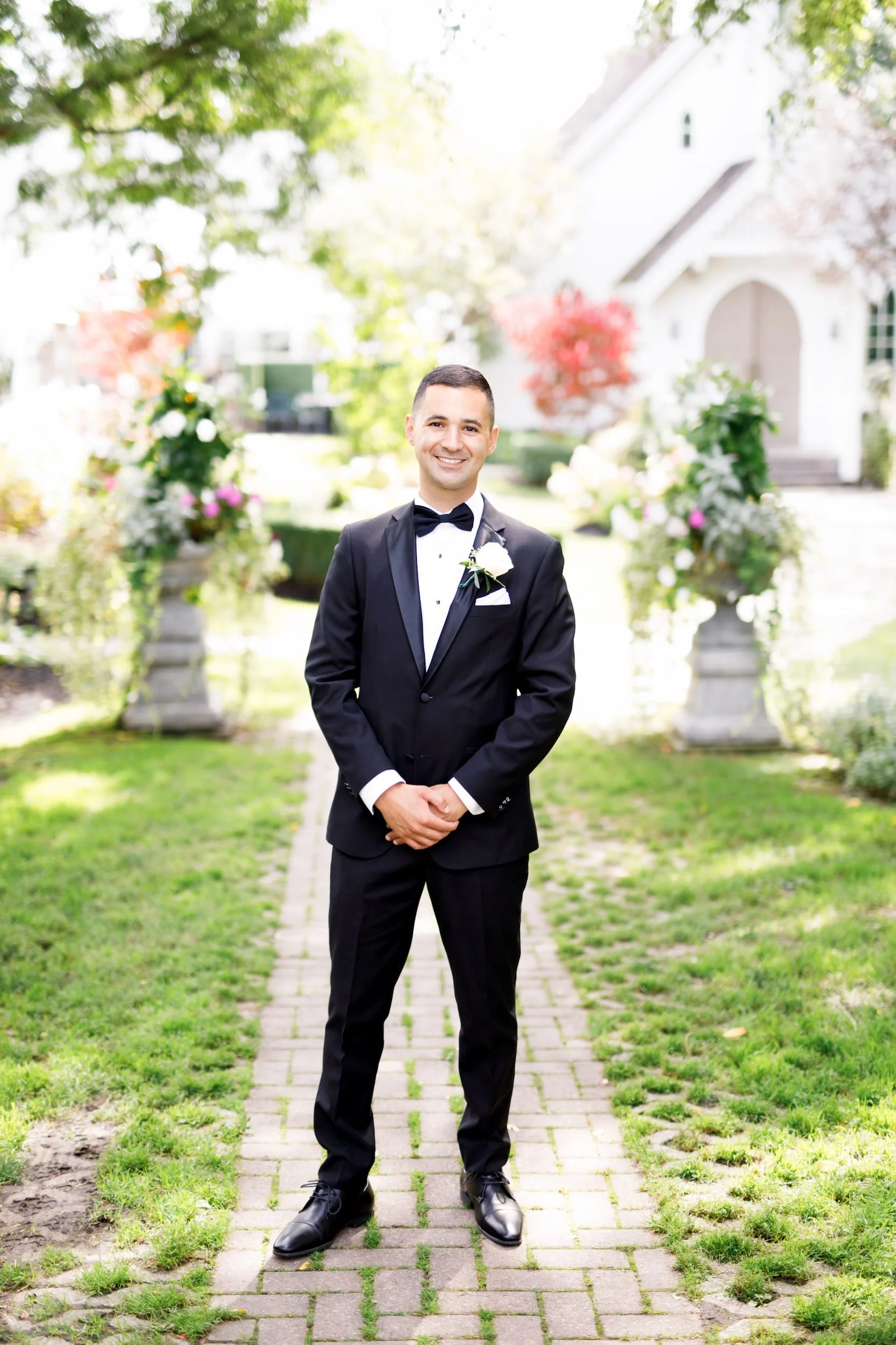 Groom portrait in garden at The Doctor’s House in Kleinburg, Ontario