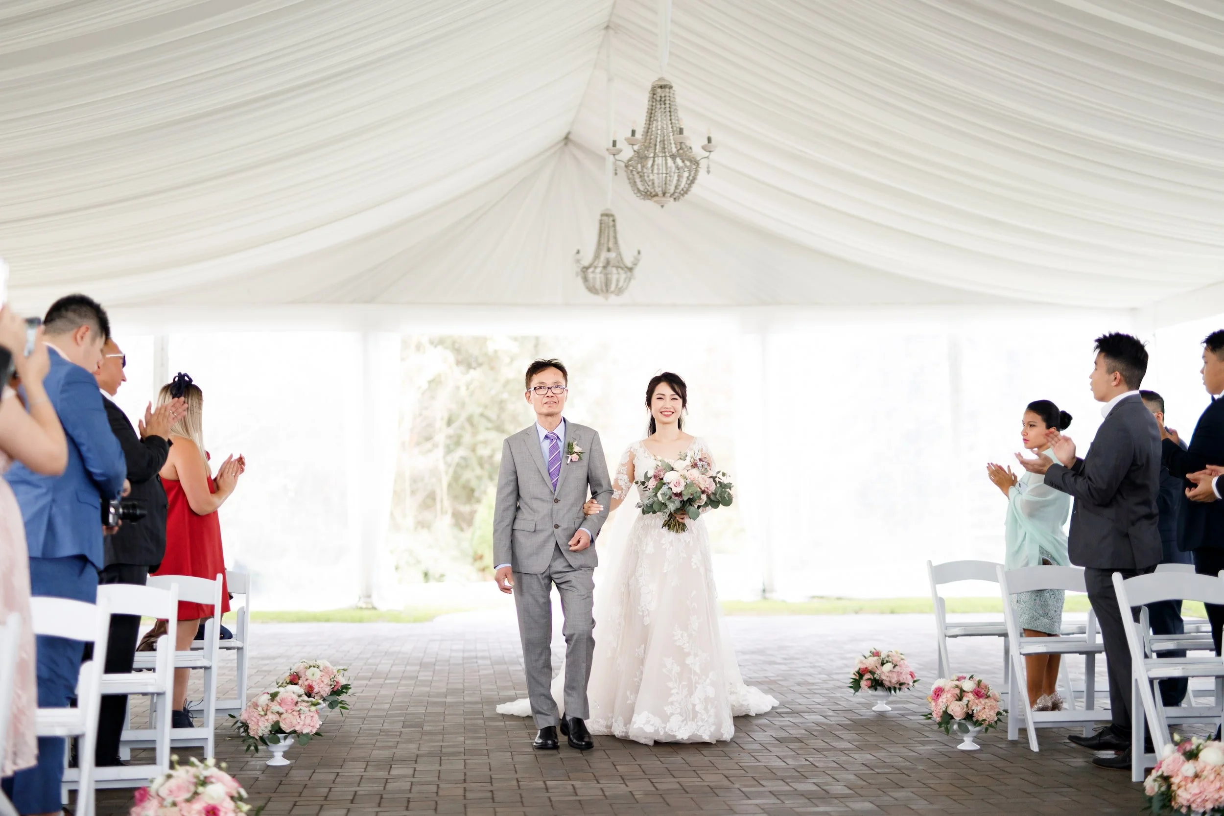 Bride walking down the aisle beneath the Arlington Estate pavilion in Vaughan
