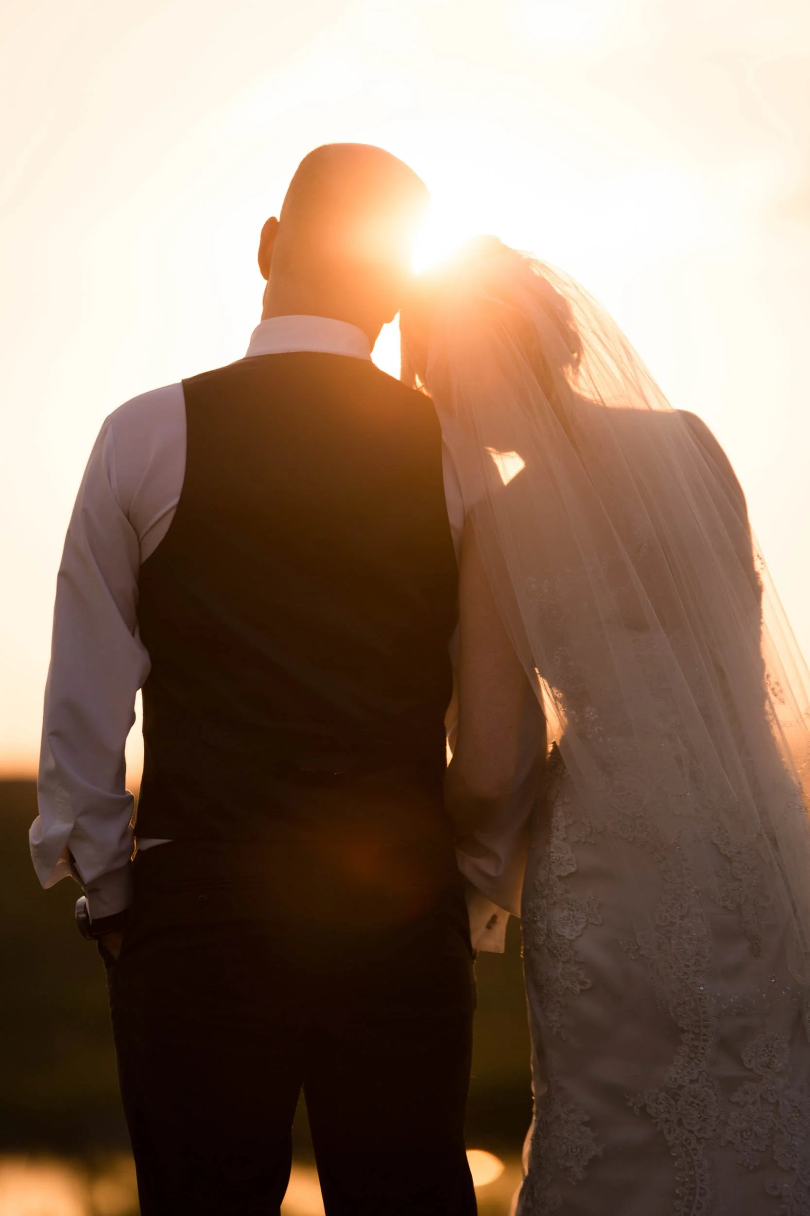 Sunset bride and groom snuggling portrait by the pond at the Arlington Estate in Vaughan