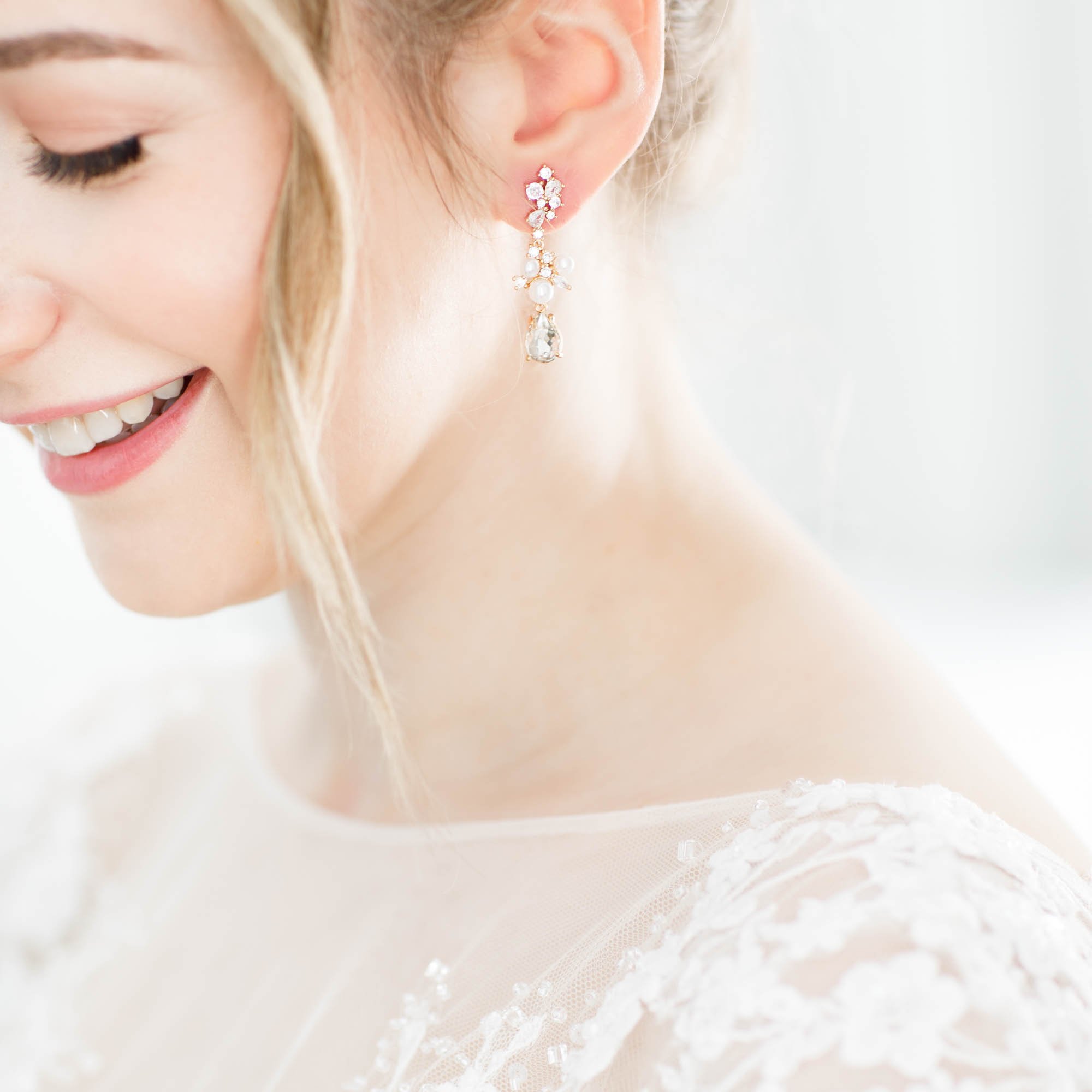 Close up of smiling bride's earring while preparing for her Mount Alverno wedding in Caledon Village — View Wedding Portfolio