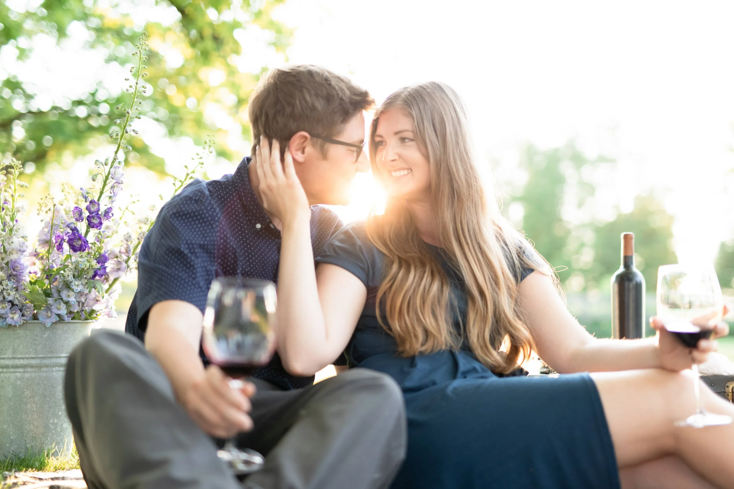 Engagement photo of a couple enjoying a sunset picnic at Bannockburn 1878 in Clinton, Ontario