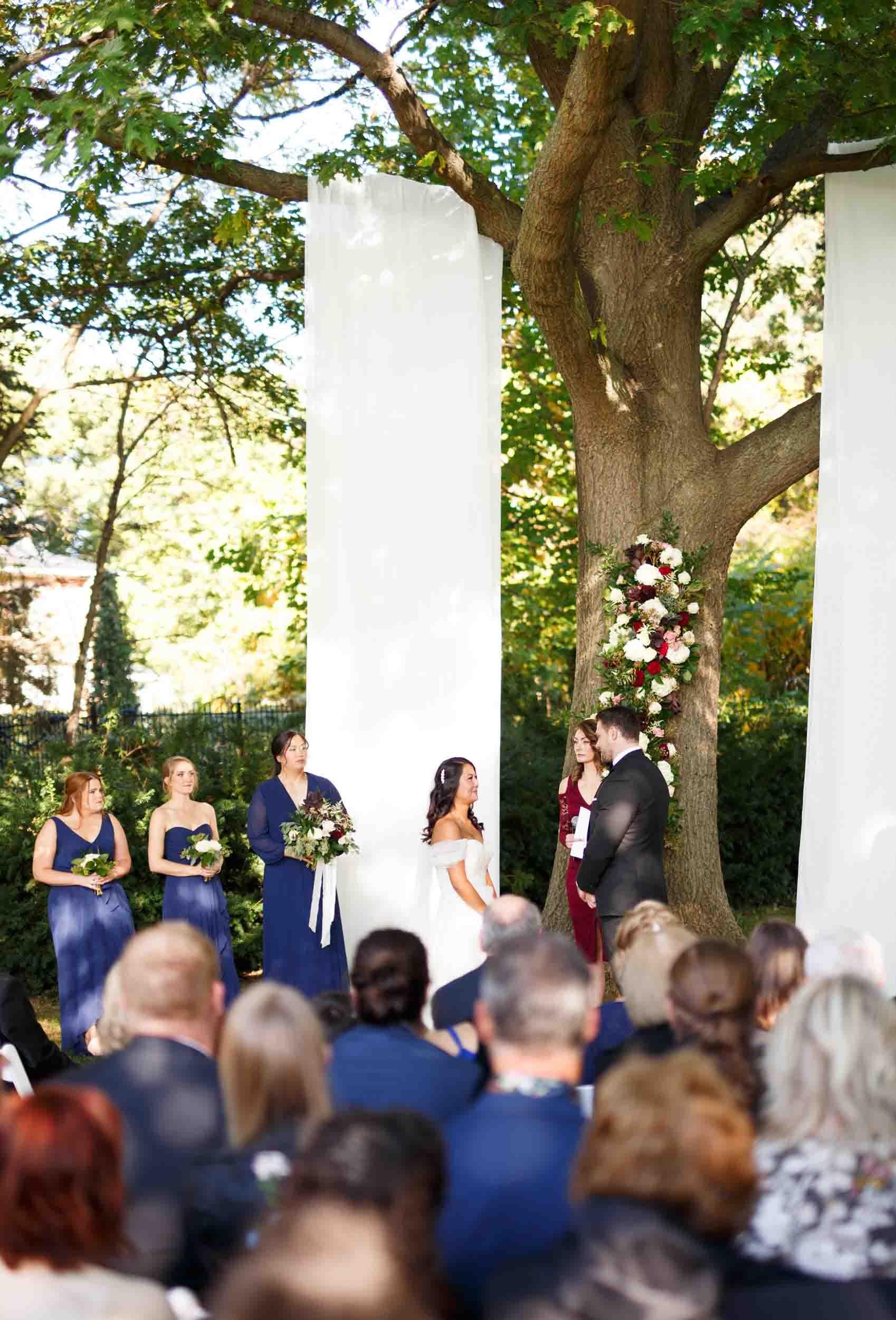 Outdoor ceremony beneath columns at Gracewood Estate in Niagara-on-the-Lake