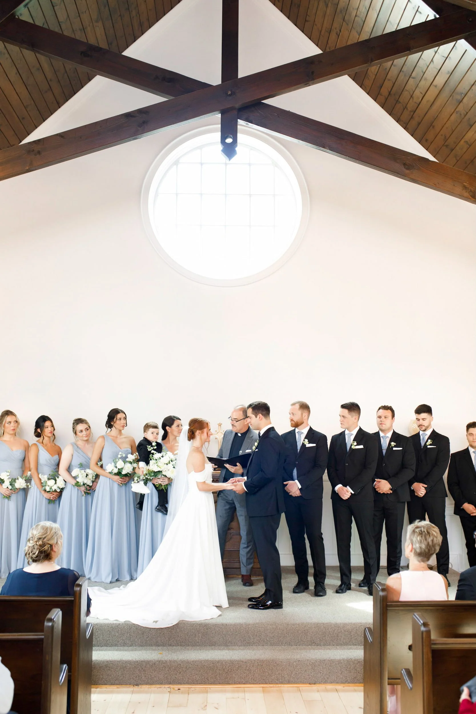 Wedding ceremony inside white chapel at The Doctor’s House in Kleinburg, Ontario