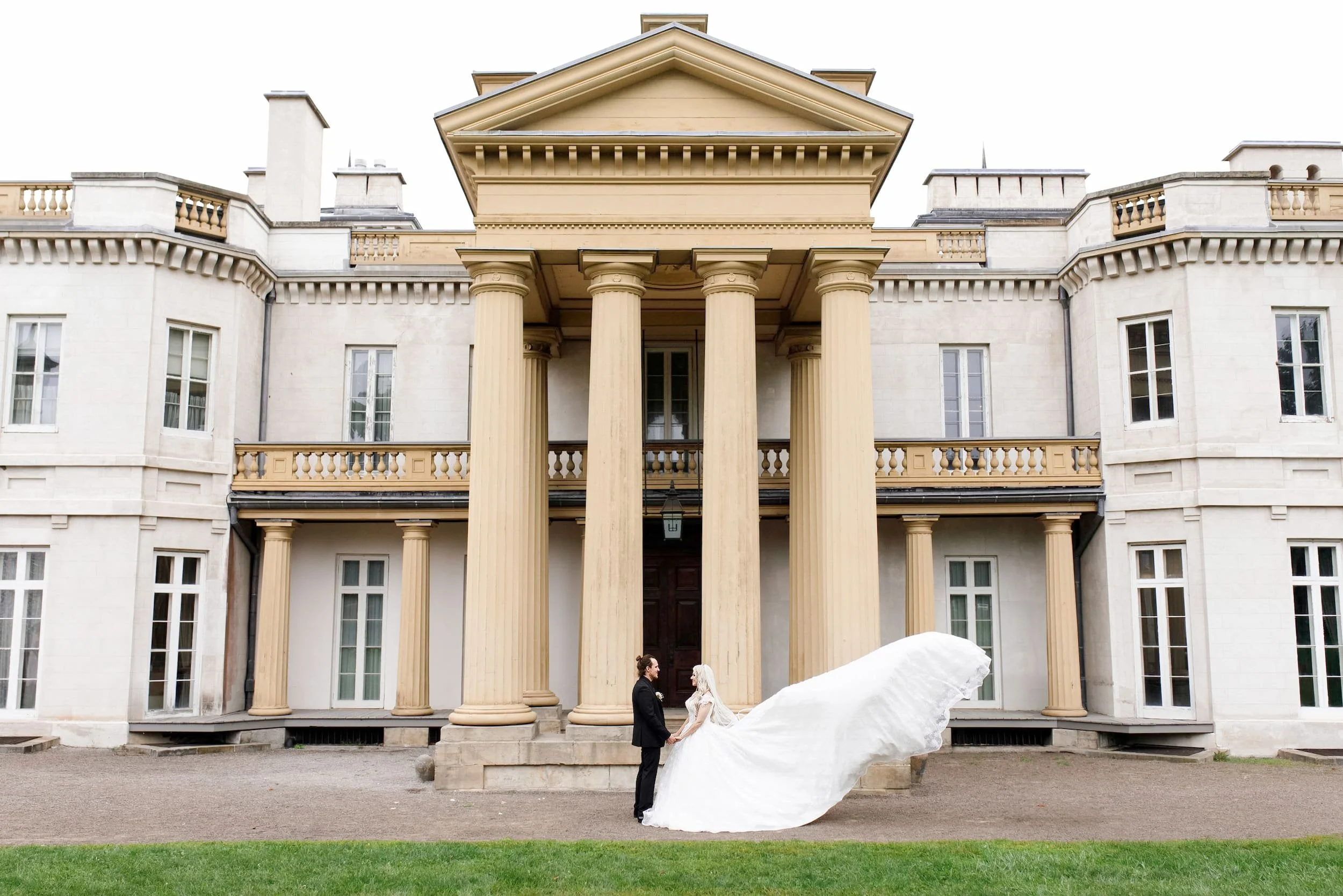 Bride and groom portrait in front of Dundurn Castle grand columns