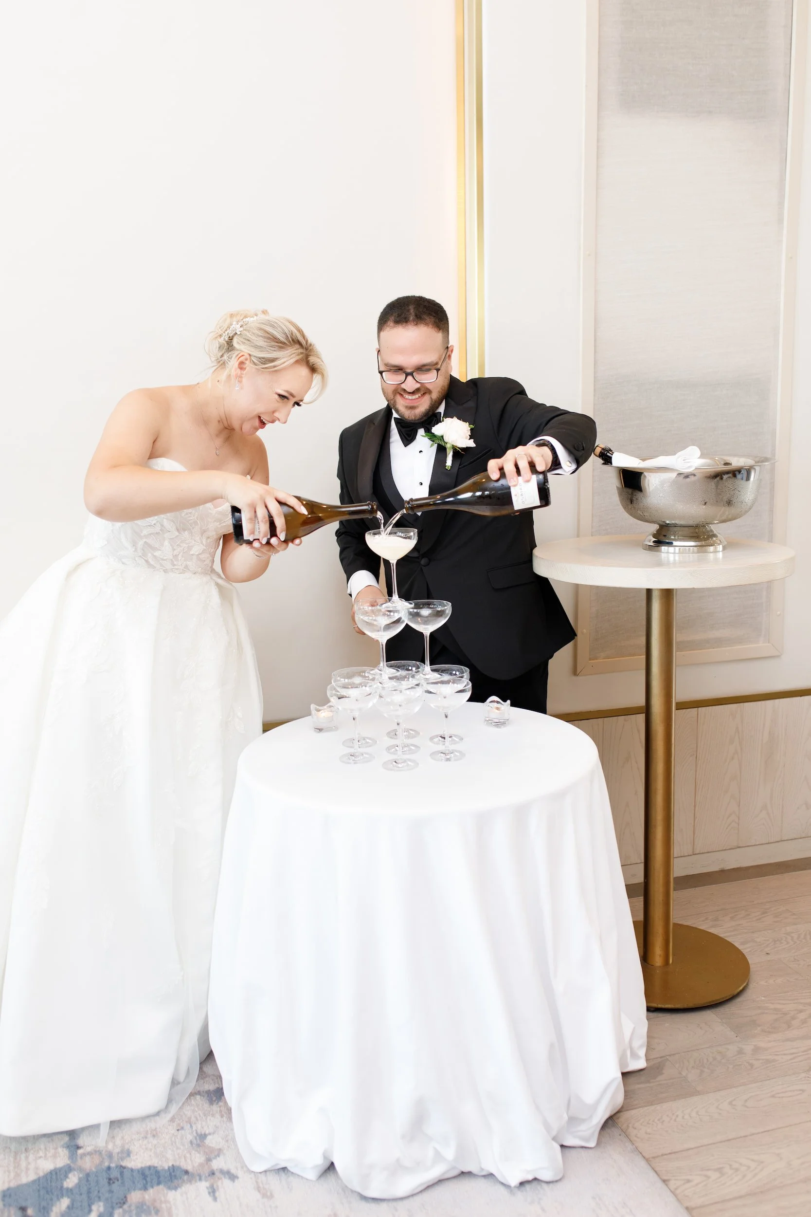 Champagne tower pour during reception at The Pearle Hotel wedding in Burlington