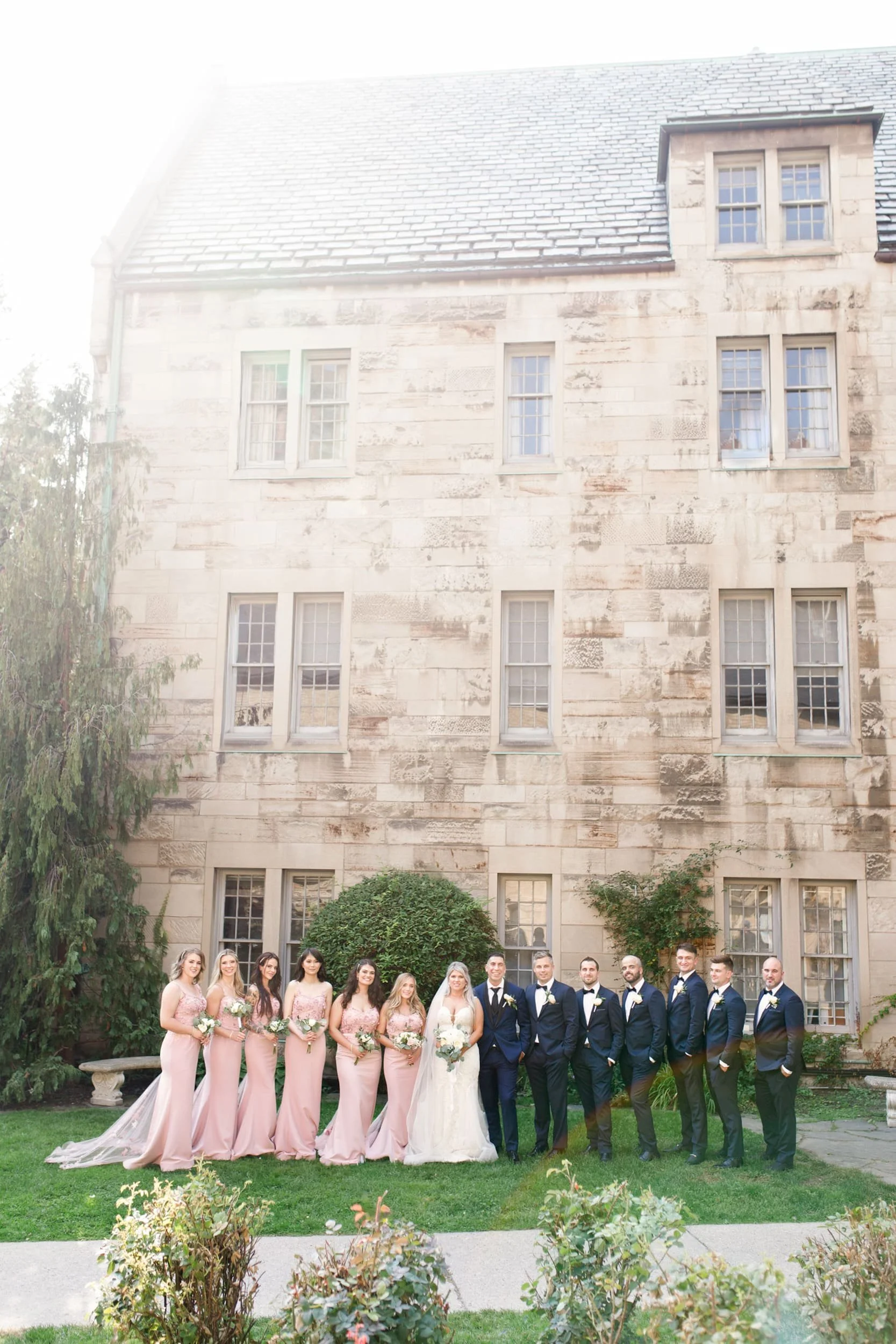 Wedding party lined up outside St. Michael’s College, University of Toronto in Toronto, Ontario