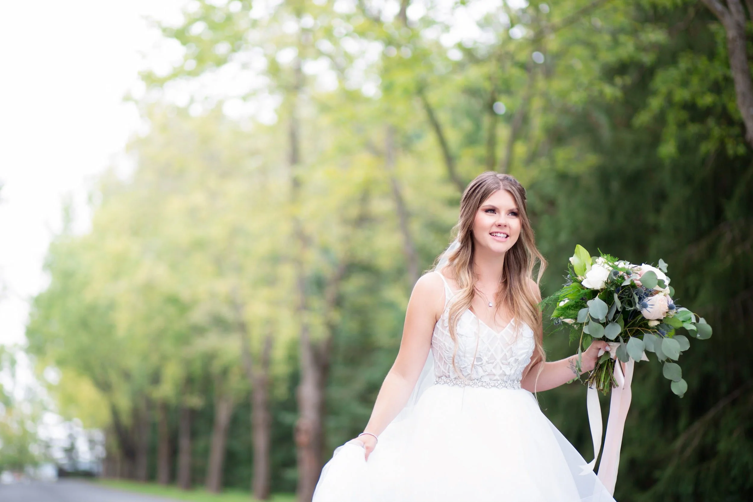 Bride walking through the grounds of Roseville Estate Winery during a Cambridge wedding in the Waterloo Region