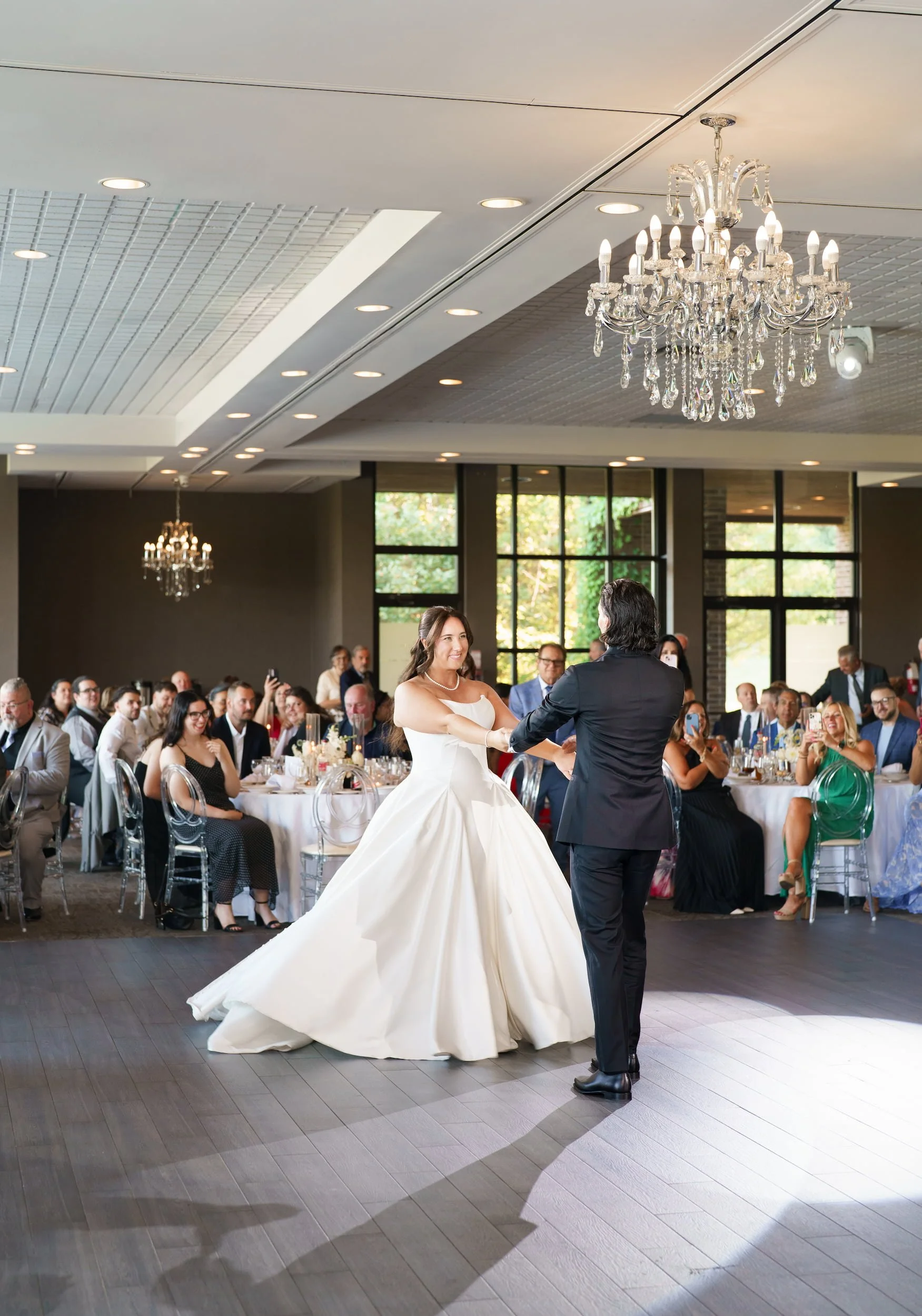 First dance beneath crystal chandelier at The Manor Event Venue in King, Ontario
