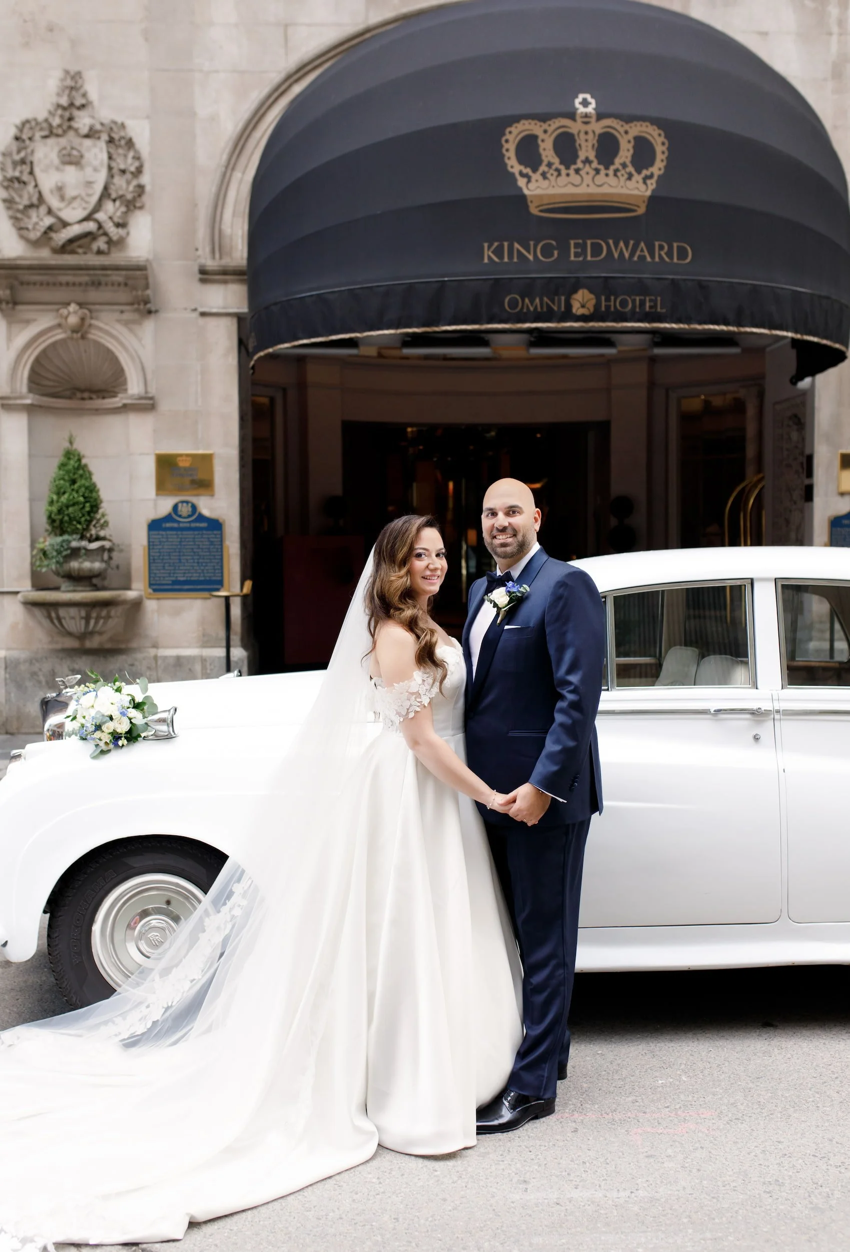Bride and groom roll royce portrait beneath the King Edward awning at Omni King Edward Hotel