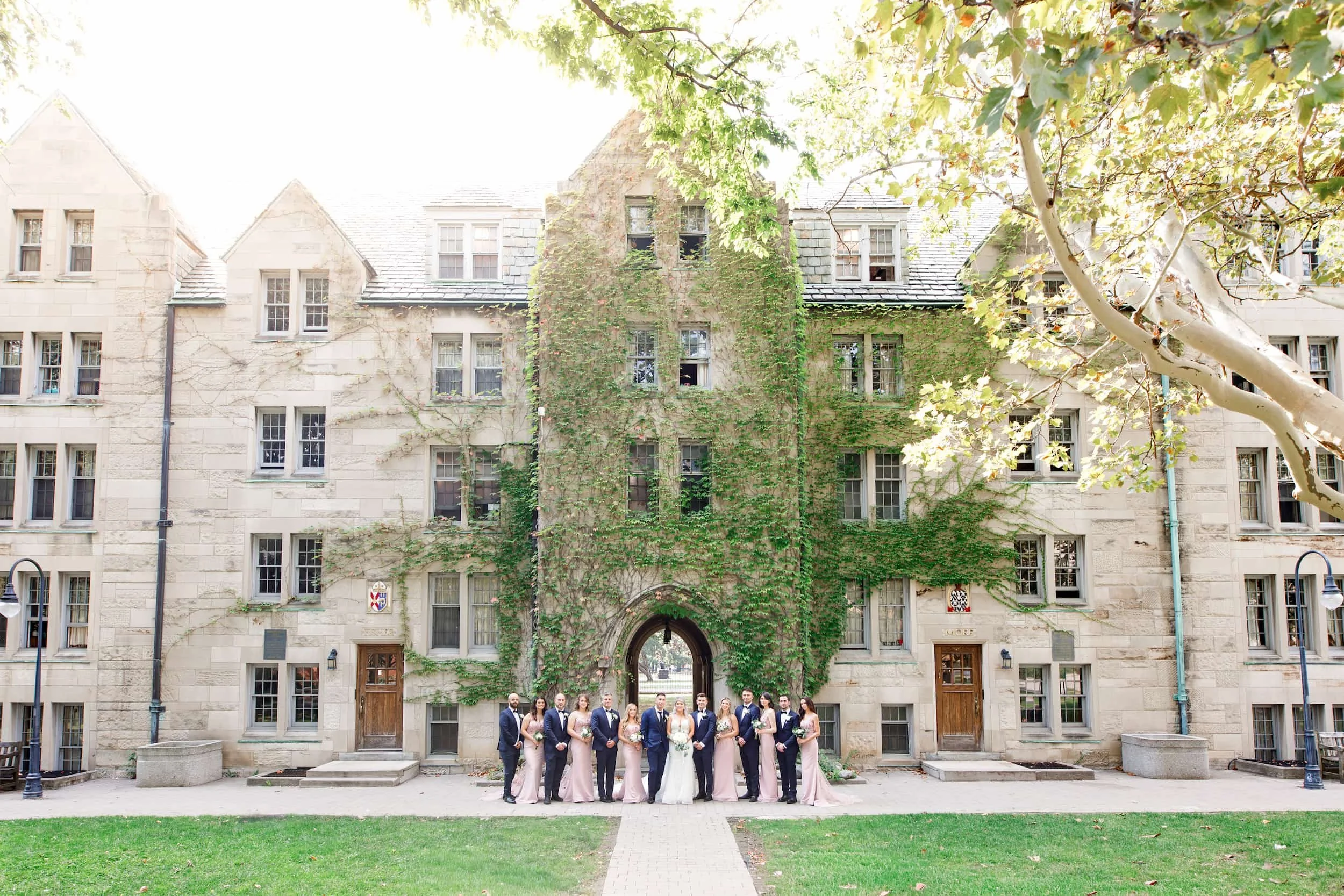 Wedding party gathered on the lawn at St. Michael’s College, University of Toronto in Toronto, Ontario