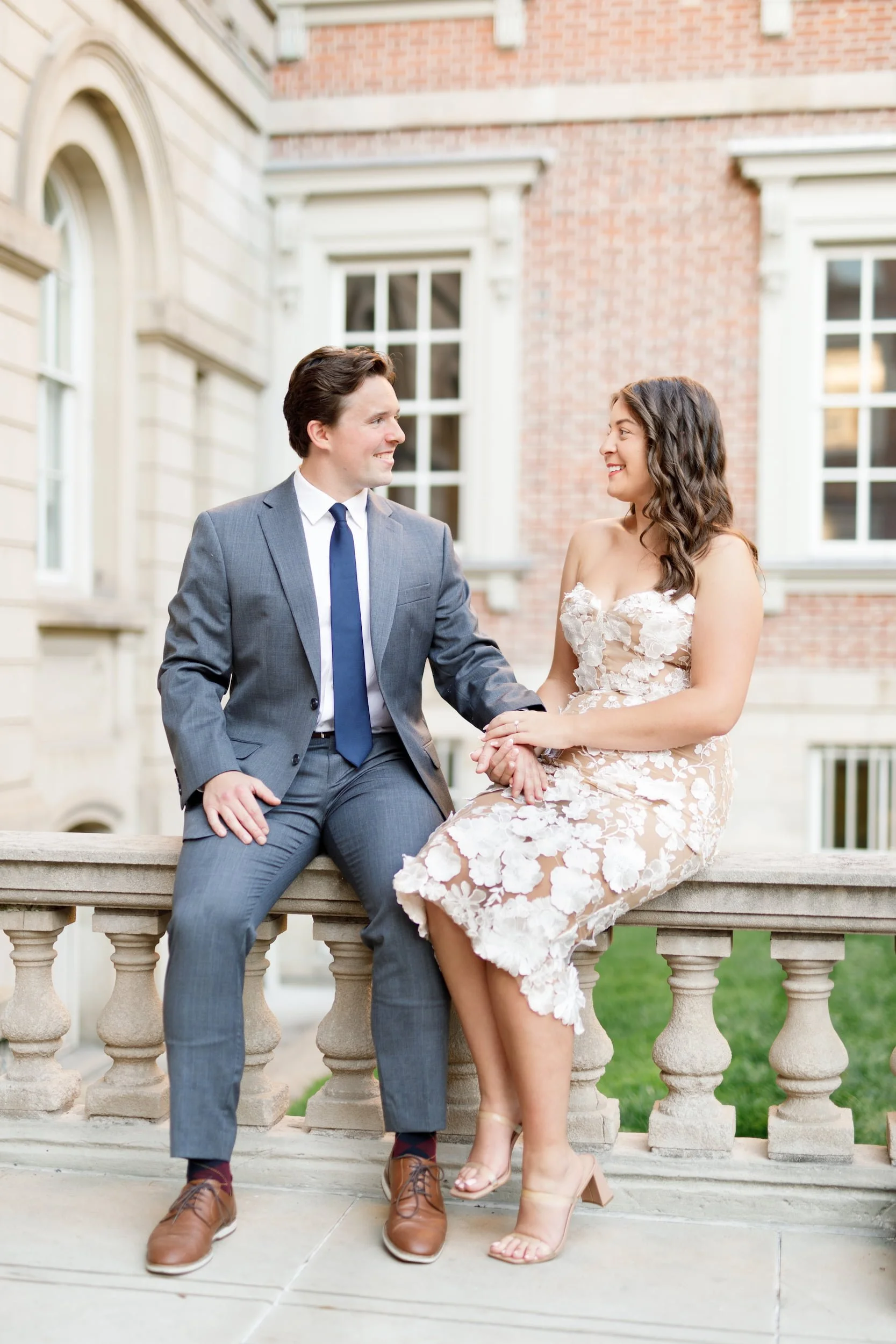 Engagement portrait on stone balustrade at Osgoode Hall in downtown Toronto