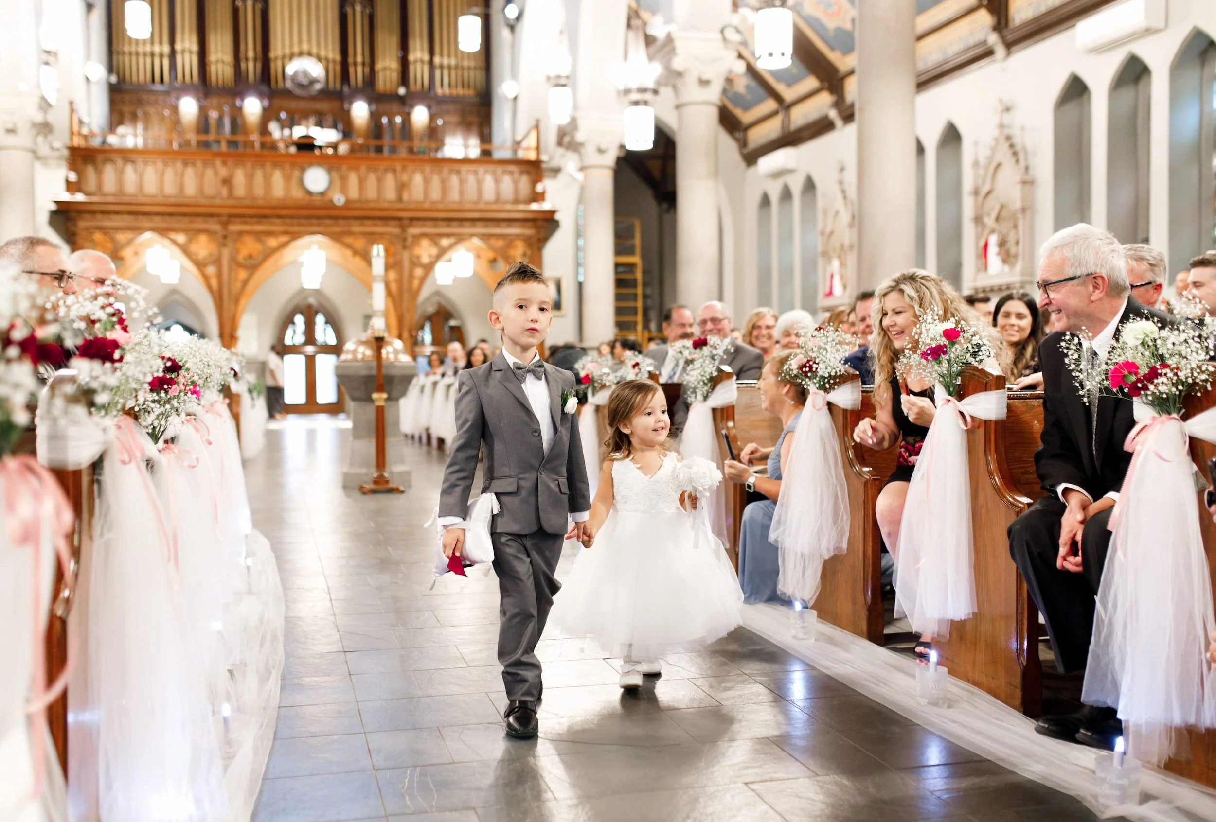 Flower girl and Ring Bearer walking down the aisle during a Hamilton Ontario wedding ceremony processional.
