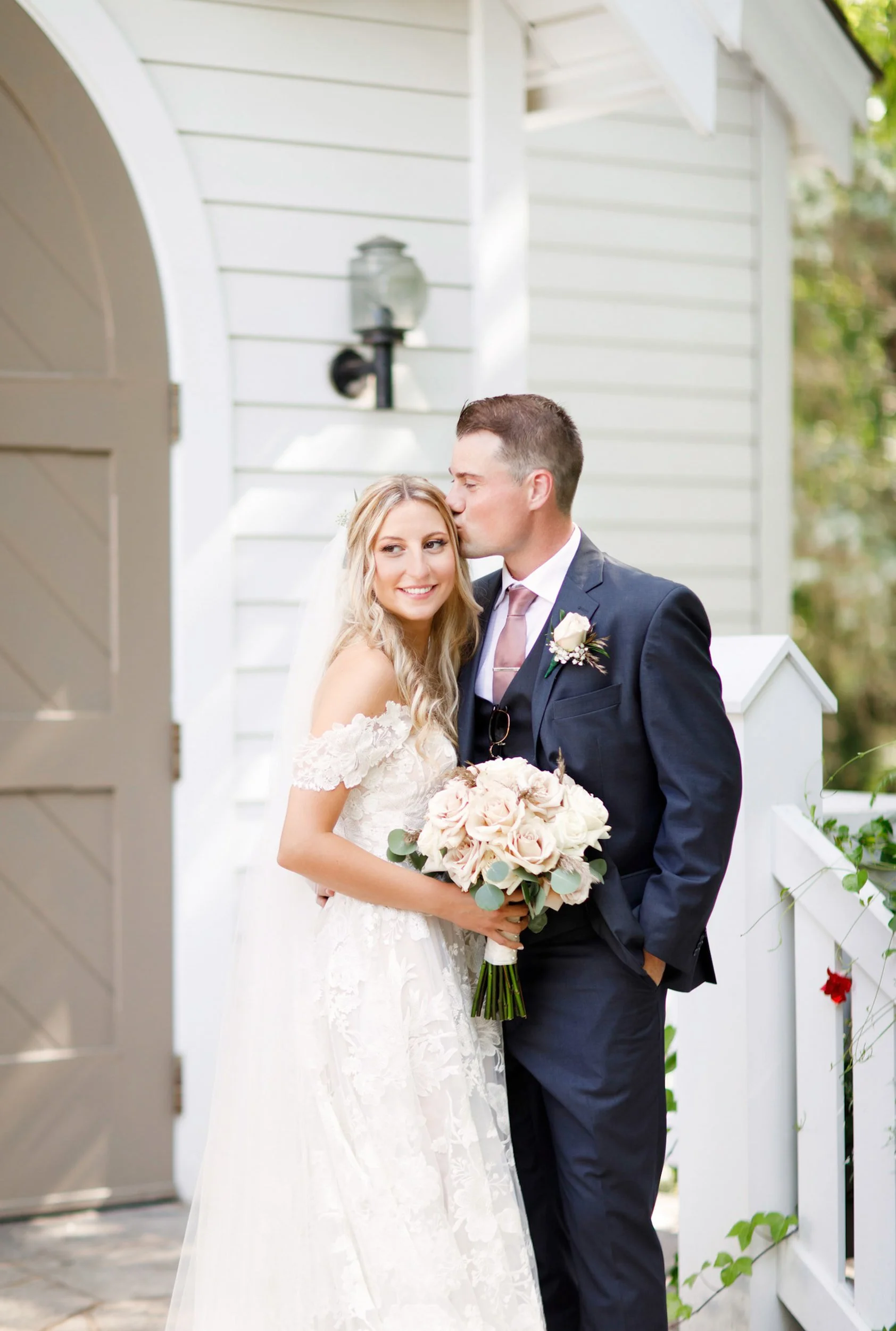 Bride and groom portrait on chapel steps at The Doctor’s House in Kleinburg, Ontario