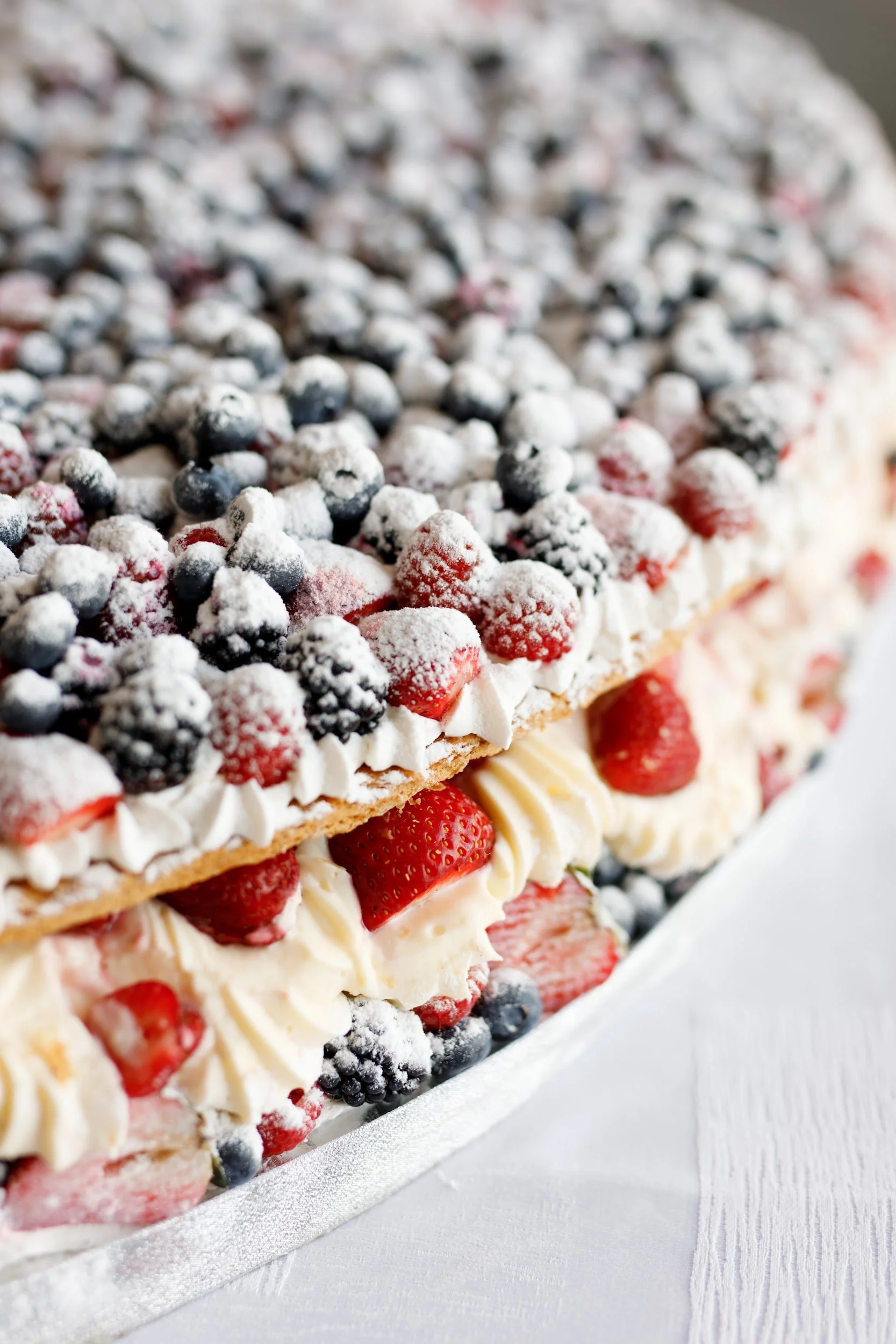Berry wedding cake with strawberries and blueberries at The Manor Event Venue wedding reception in King, Ontario