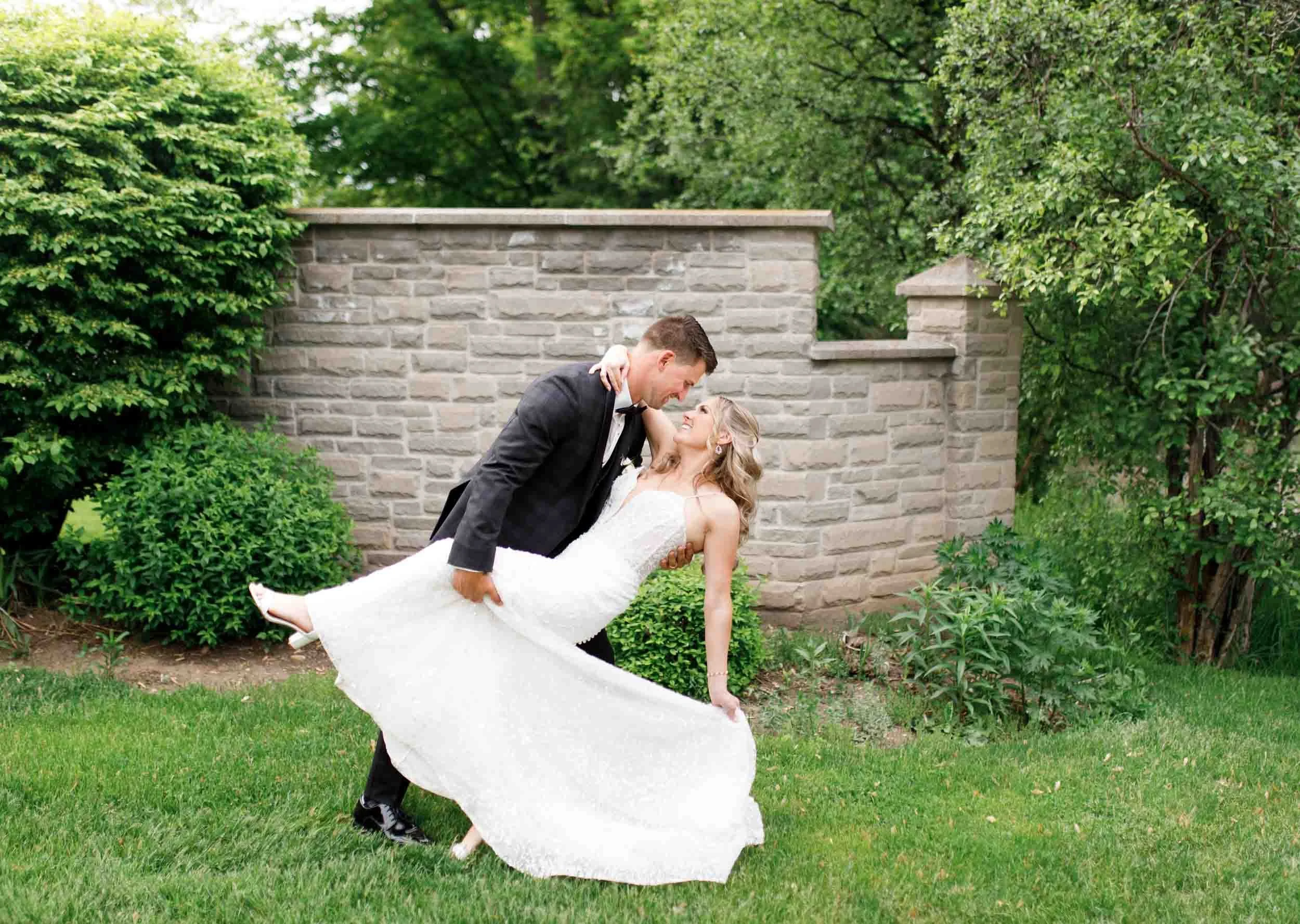 Bride and groom portrait near the stone wall at the Ancaster Mill in Ancaster