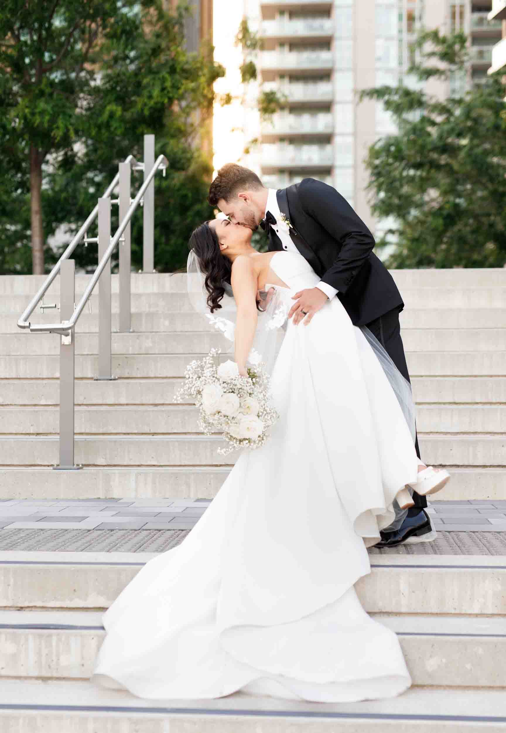 Romantic dip on hotel steps at The Pearle Hotel wedding in Burlington, Ontario